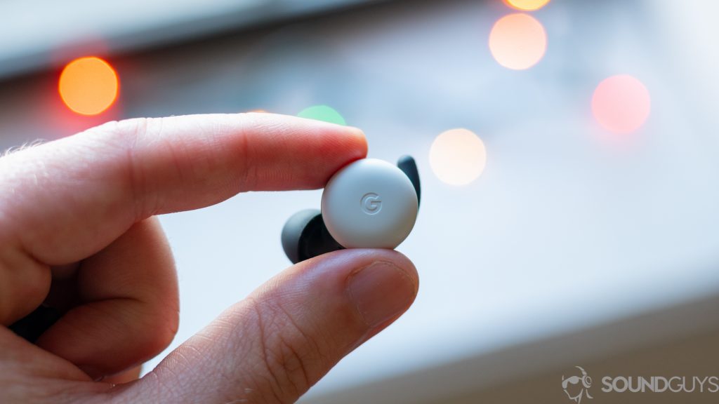 A closeup image of the left Google Pixel Bud between two fingers