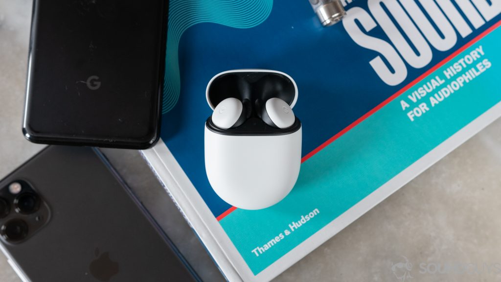 A picture of the Google Pixel Buds 2020 true wireless earbuds next to a Google smartphone.