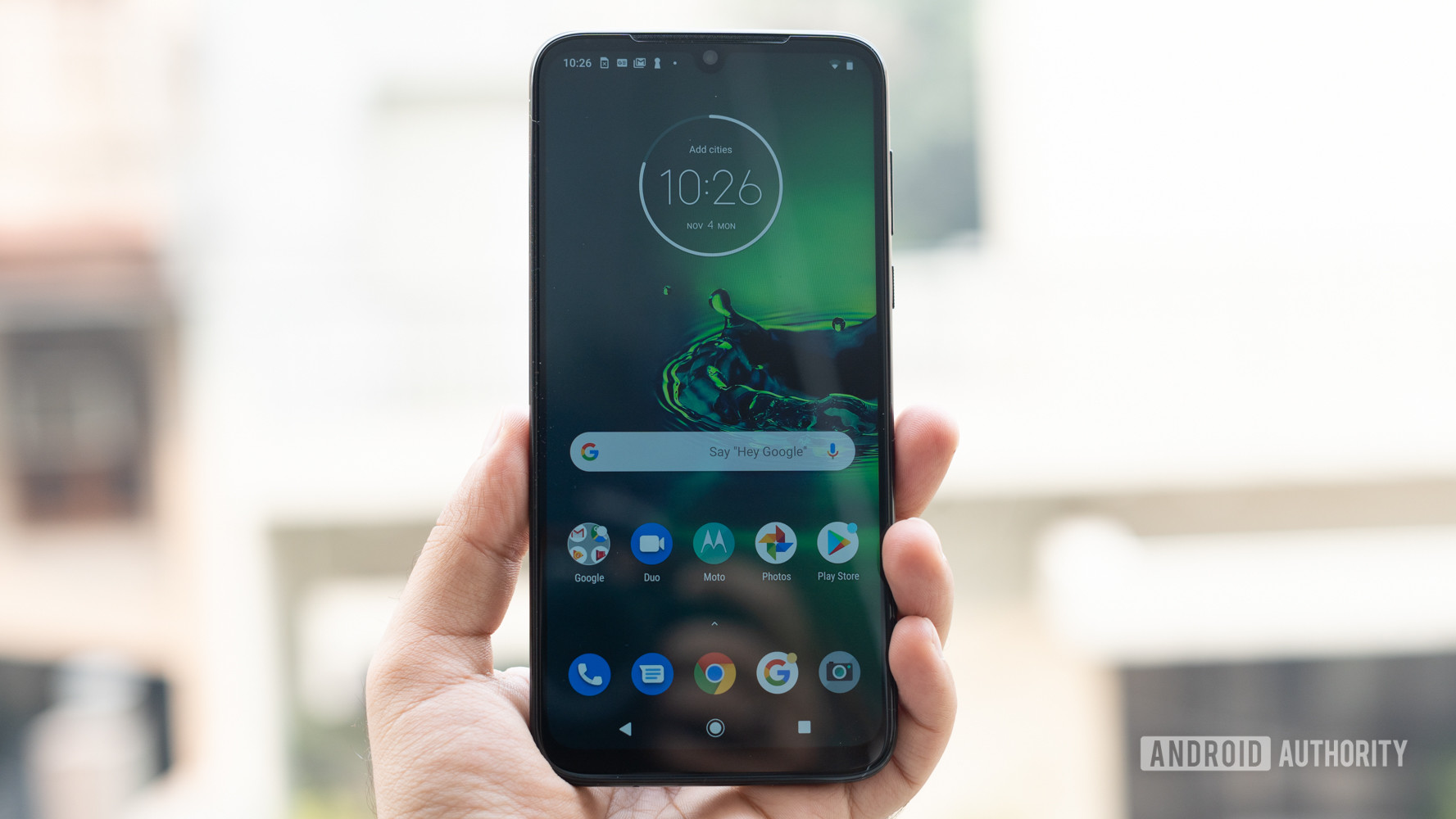 Moto G8 Plus showing display homescreen in hand