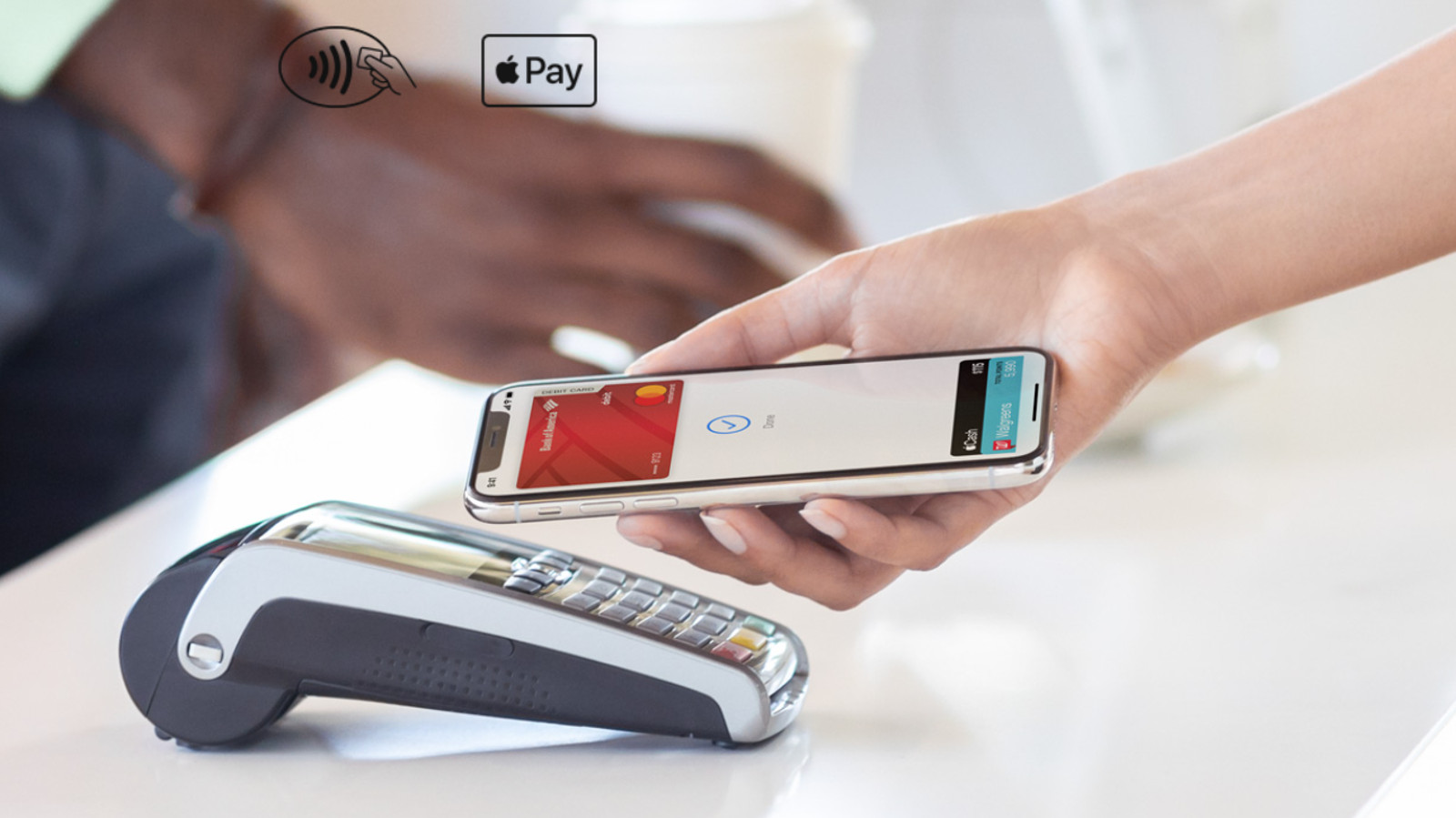 Apple Pay on an iPhone at a point of sale terminal.