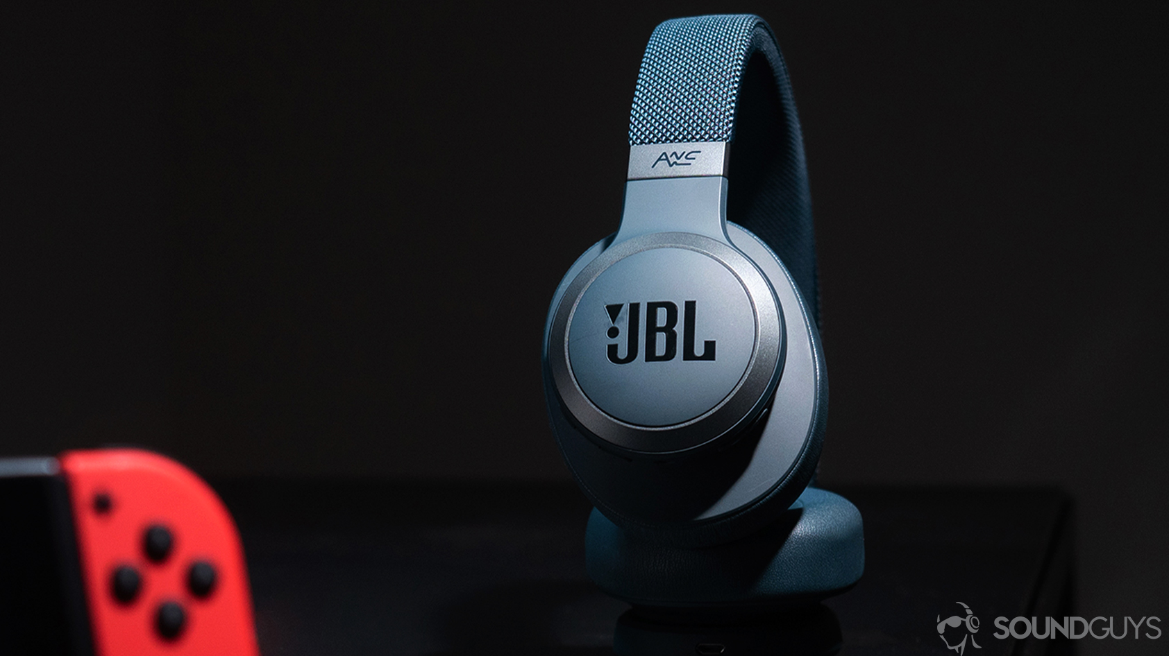 The JBL Live 650BTNC headphones with a Nintendo Switch in the foreground.