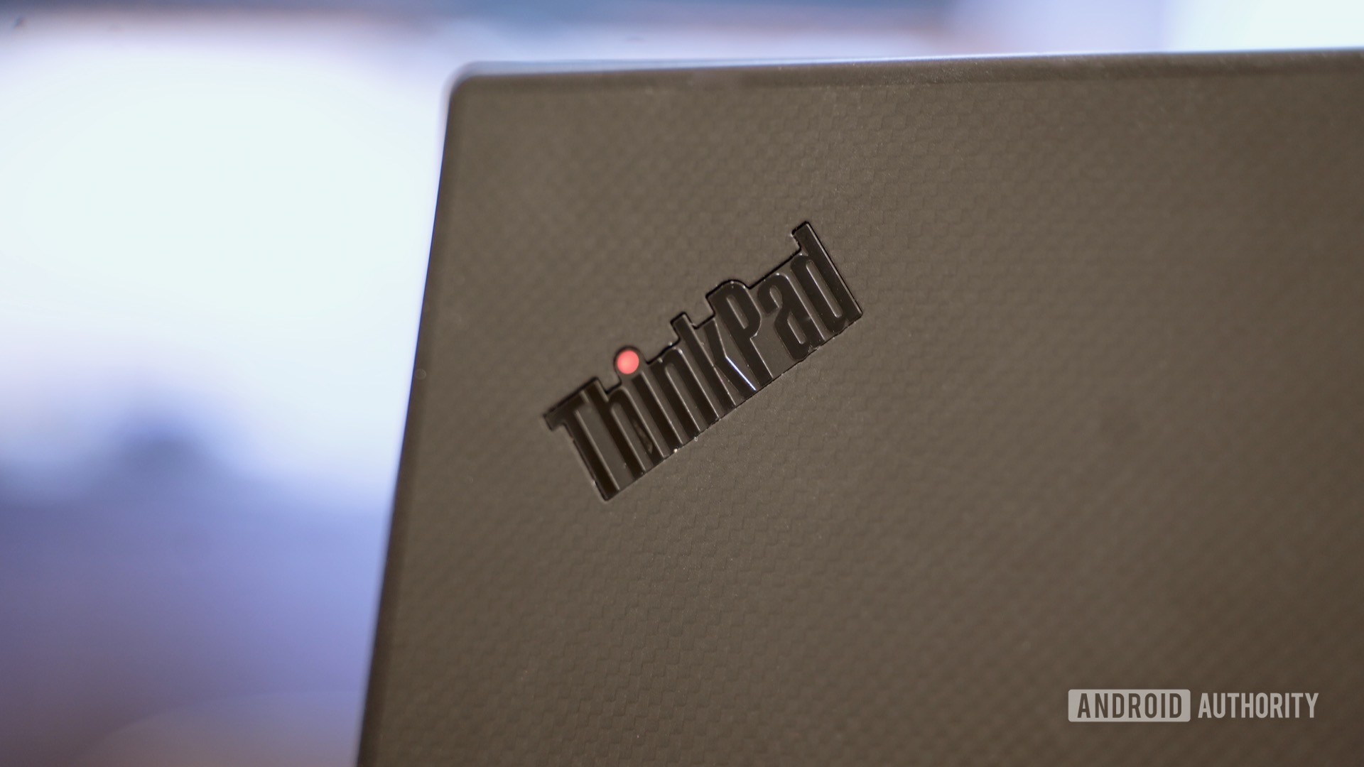 Lenovo ThinkPad X1 Carbon review logo closeup with red dot