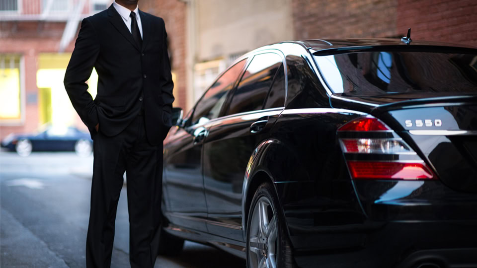 Uber Connect driver standing next to car