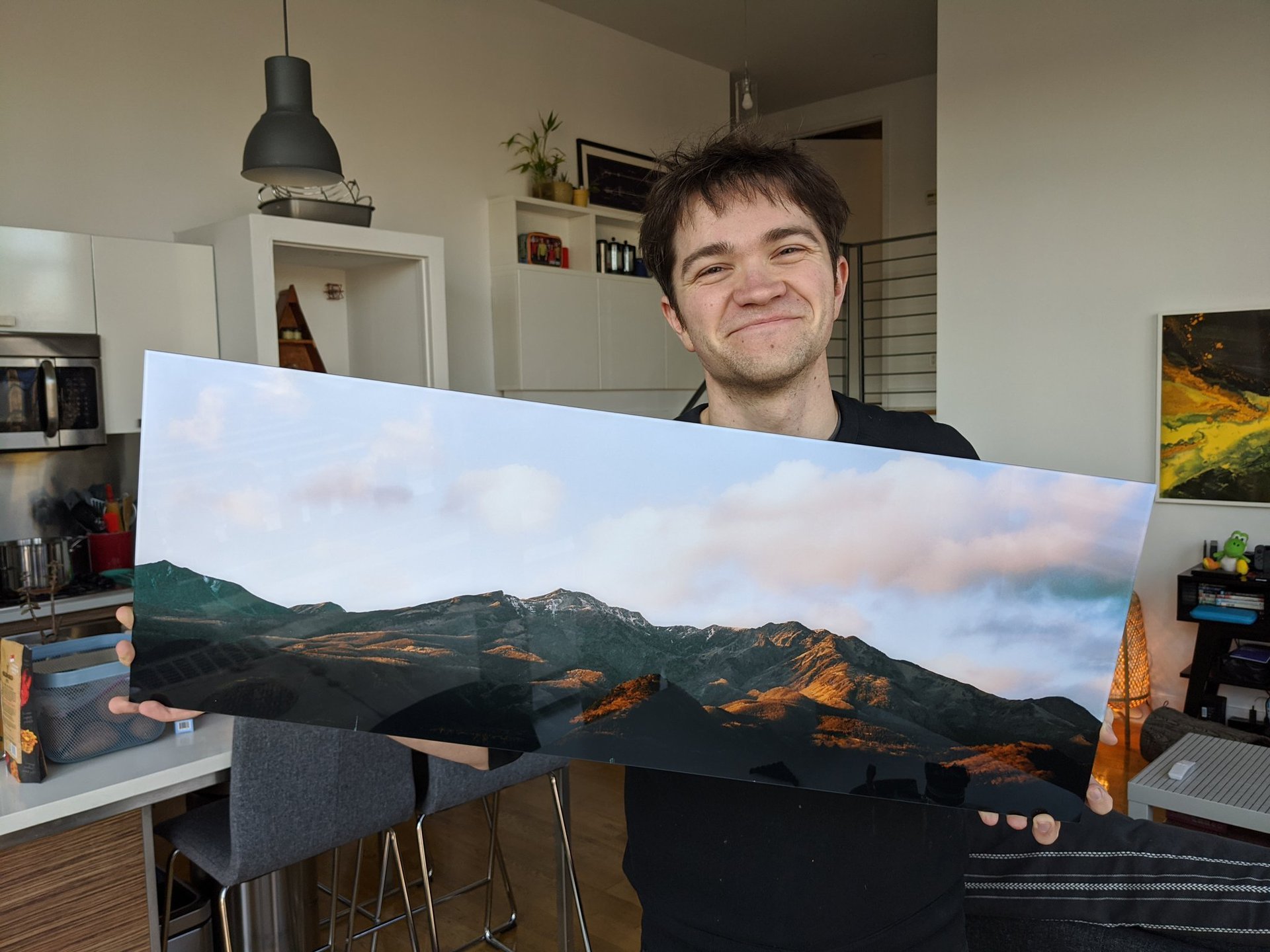 David Imel holding a large print of his photography