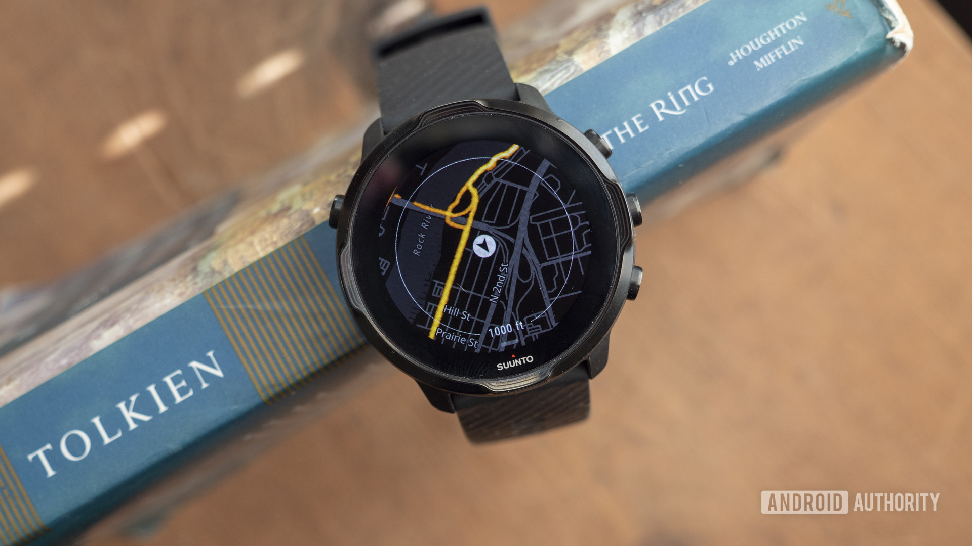 A Suunto 7 rests on a book with the display showing the heatmaps feature.