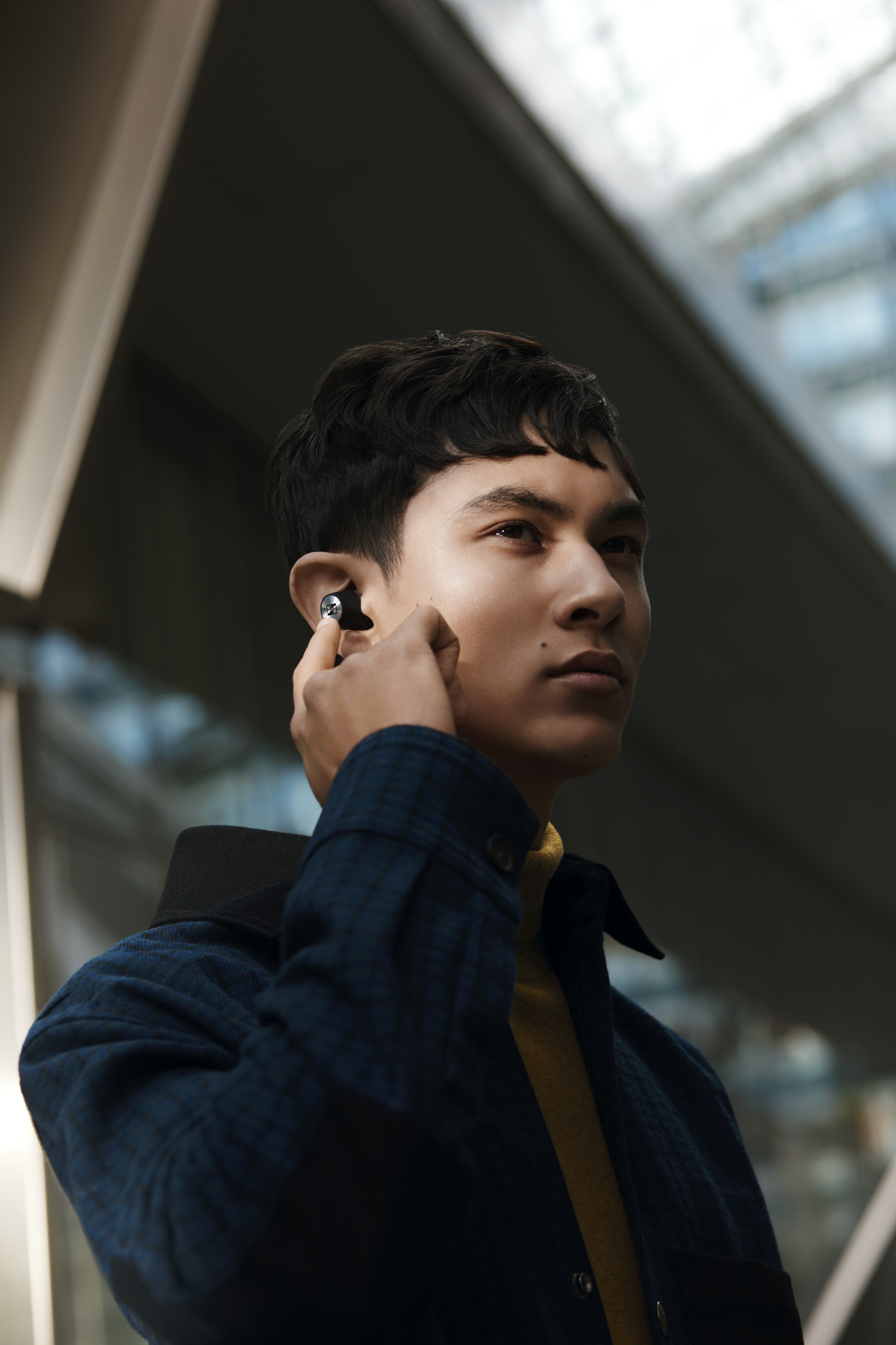 A man wearing the Sennheiser Momentum True Wireless 2 earbuds.