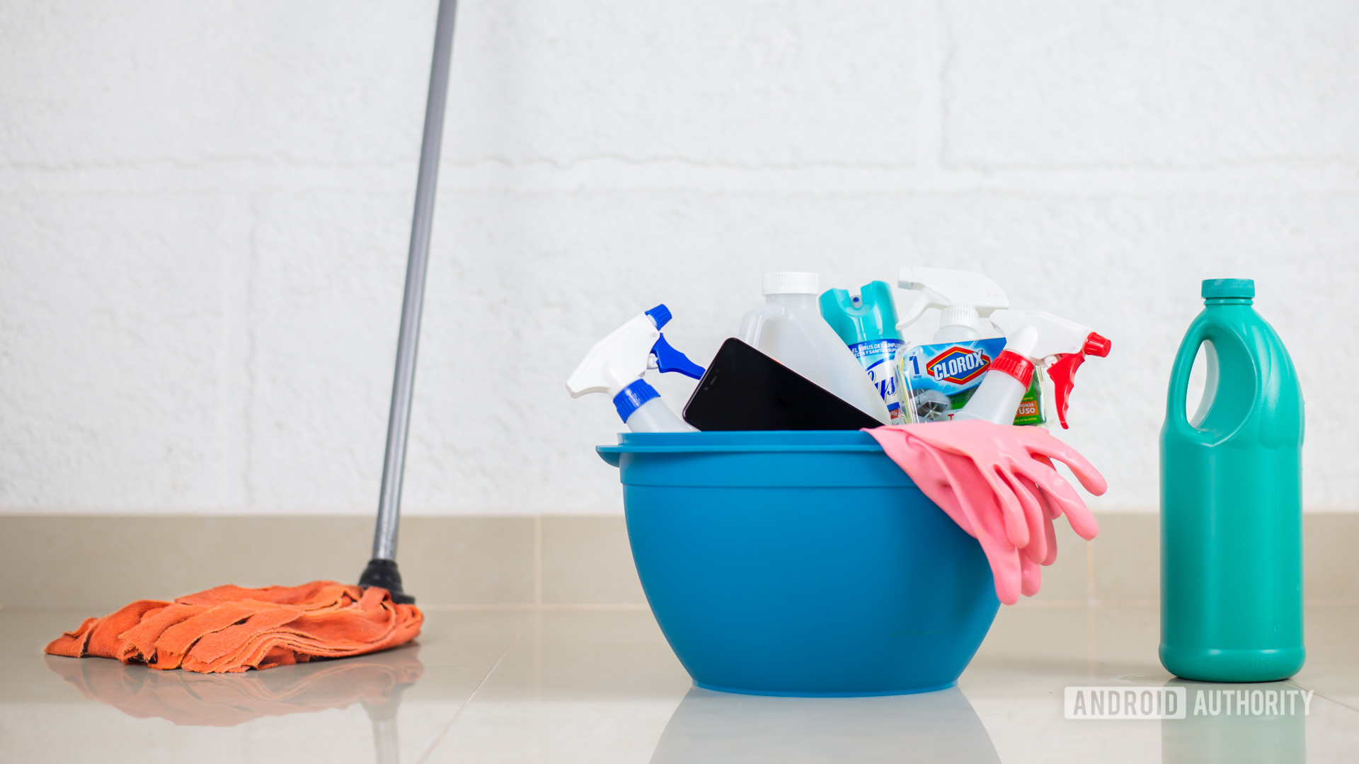 House cleaning products with phone stock photo