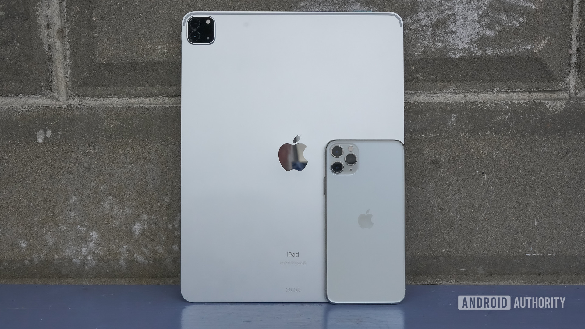 Apple iPad Pro 2020 standing against wall with iPhone 11