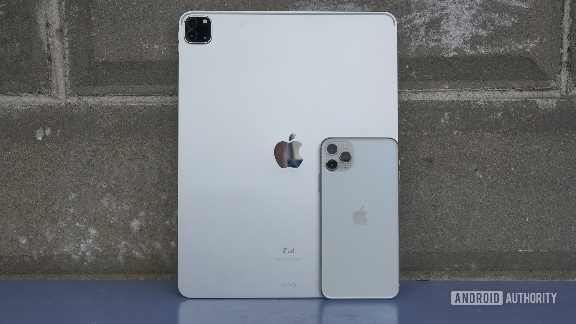 Apple iPad Pro 2020 standing against wall with iPhone 11