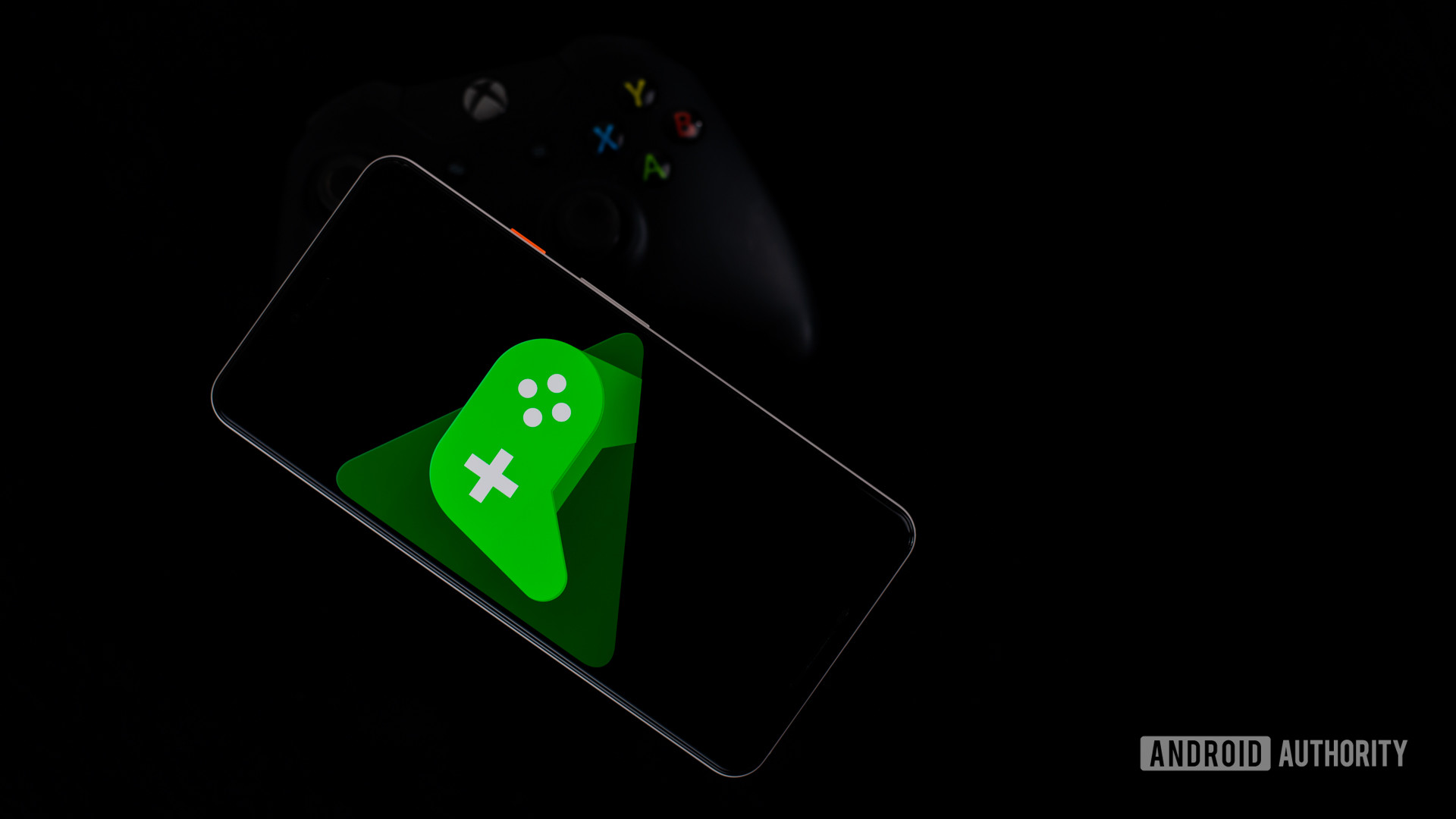 Google Play Games on smartphone with controller stock photo 4