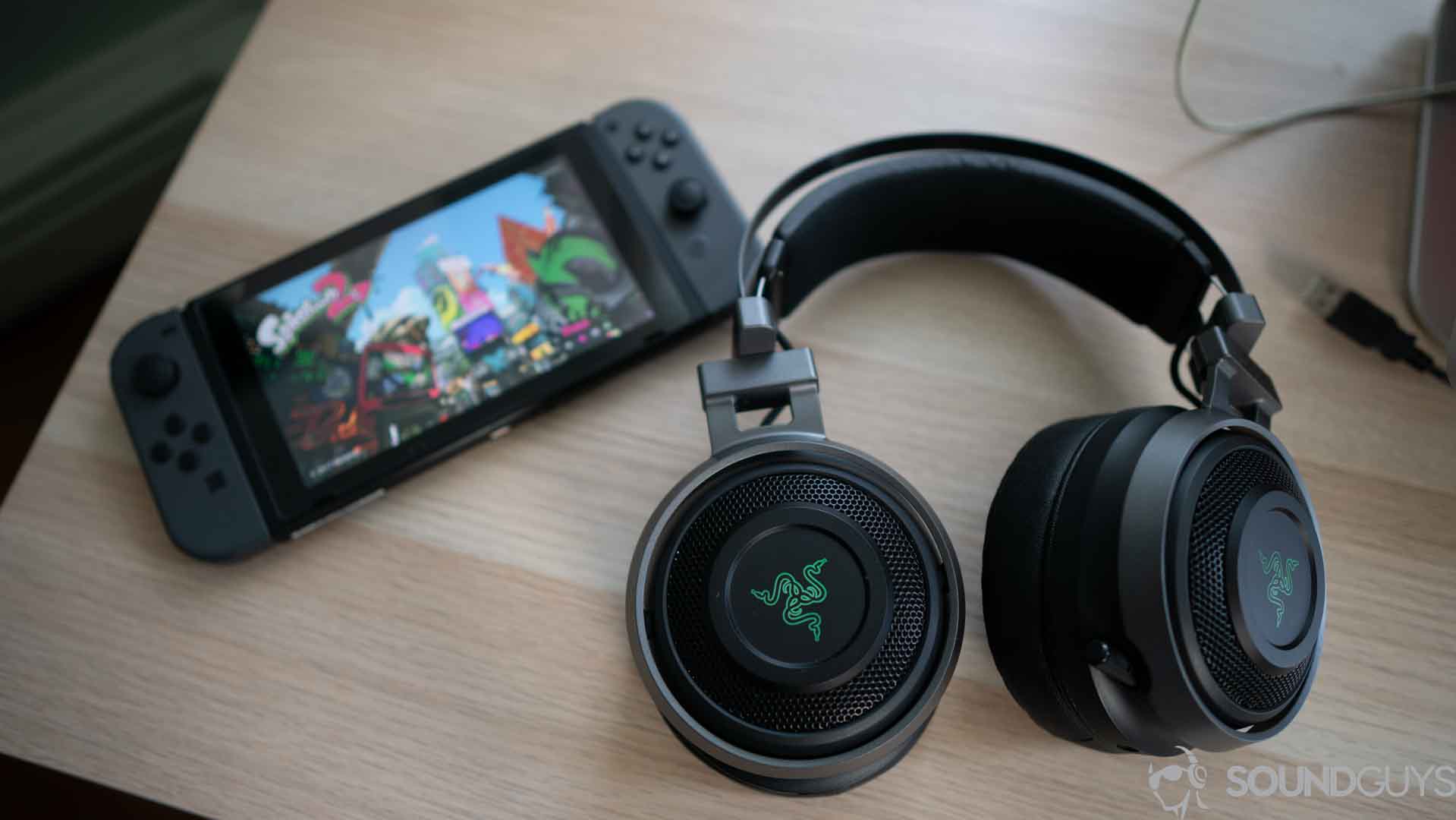 A picture of the Razer Nari Ultimate gaming headset next to a nintendo switch.