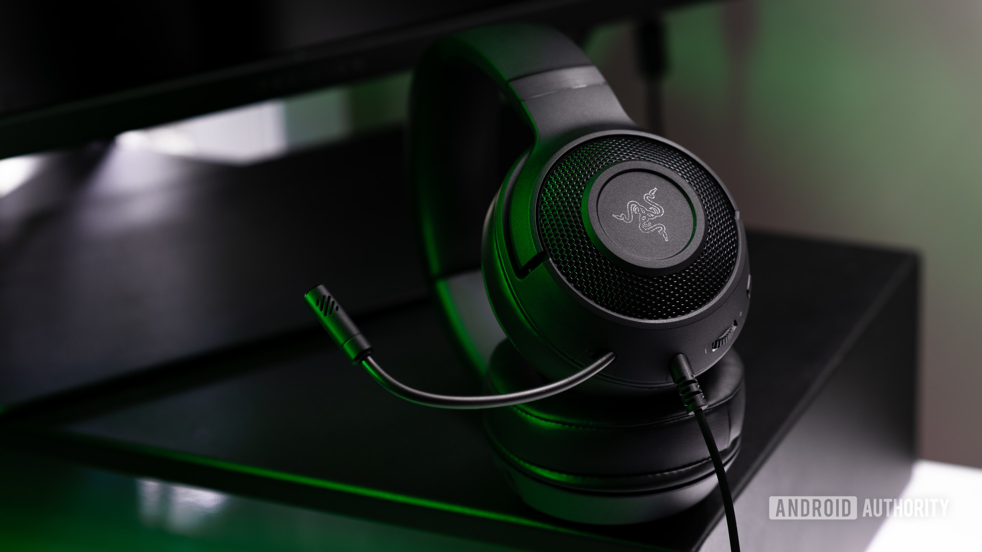 A picture of the Razer Kraken X wired gaming headset against a computer monitor.