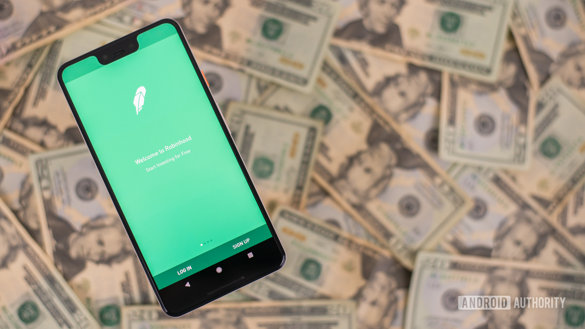 Robin Hood app on smartphone with money on background stock photo