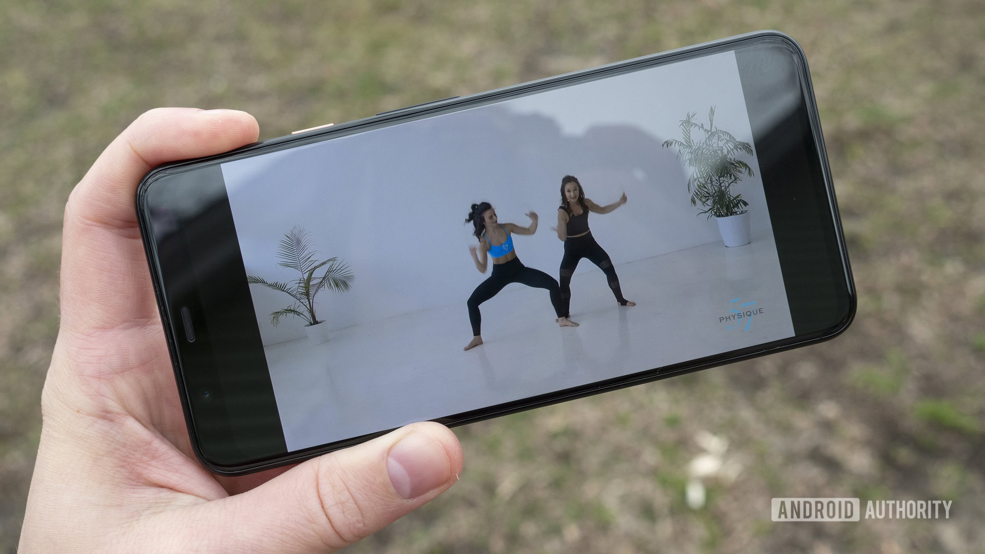 A Fitbit Premium member plays a custom workout on his smartphone. 