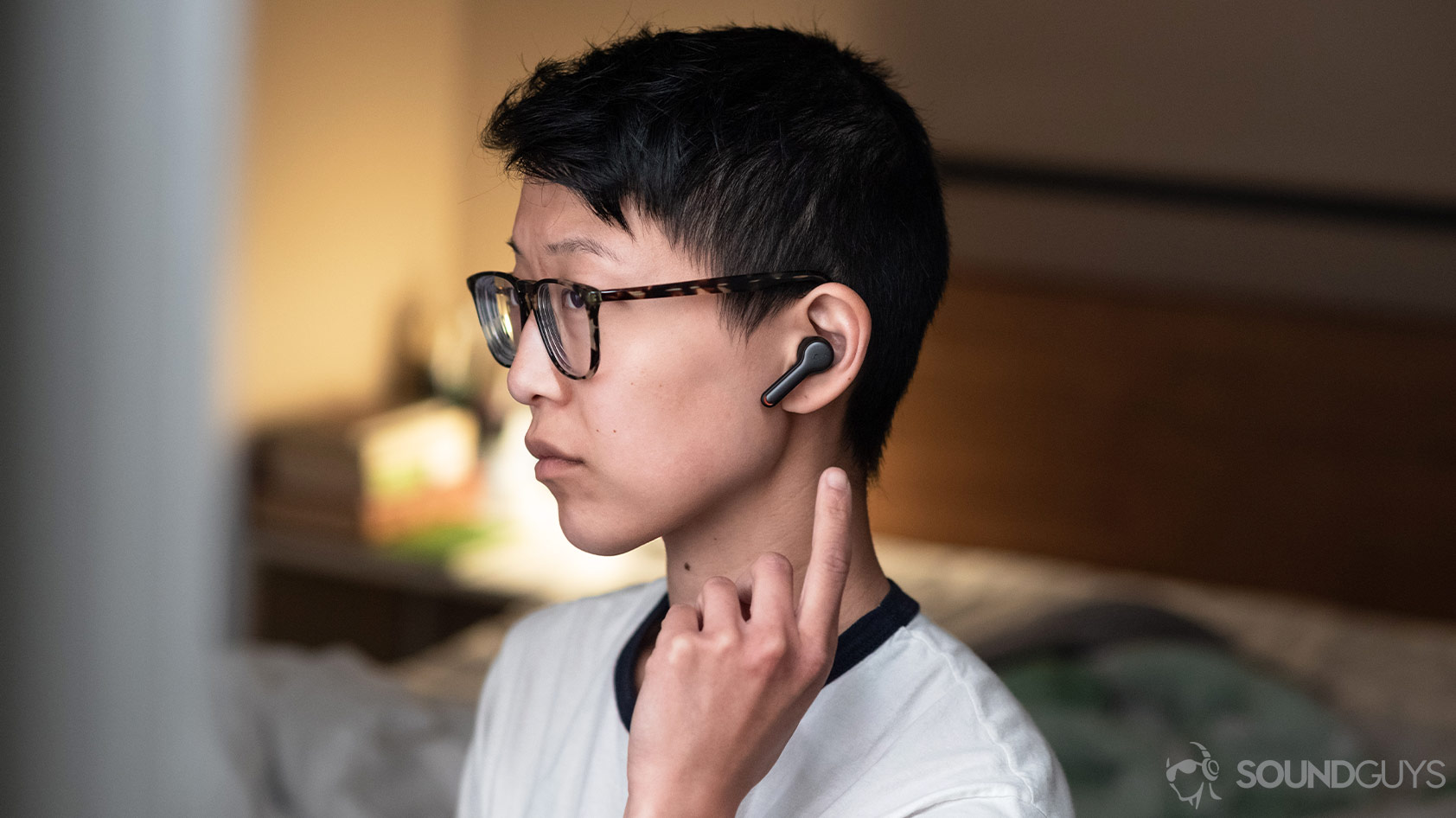 A picture of the Anker SoundCore Liberty Air 2 true wireless earbud worn by a woman using the touch controls.