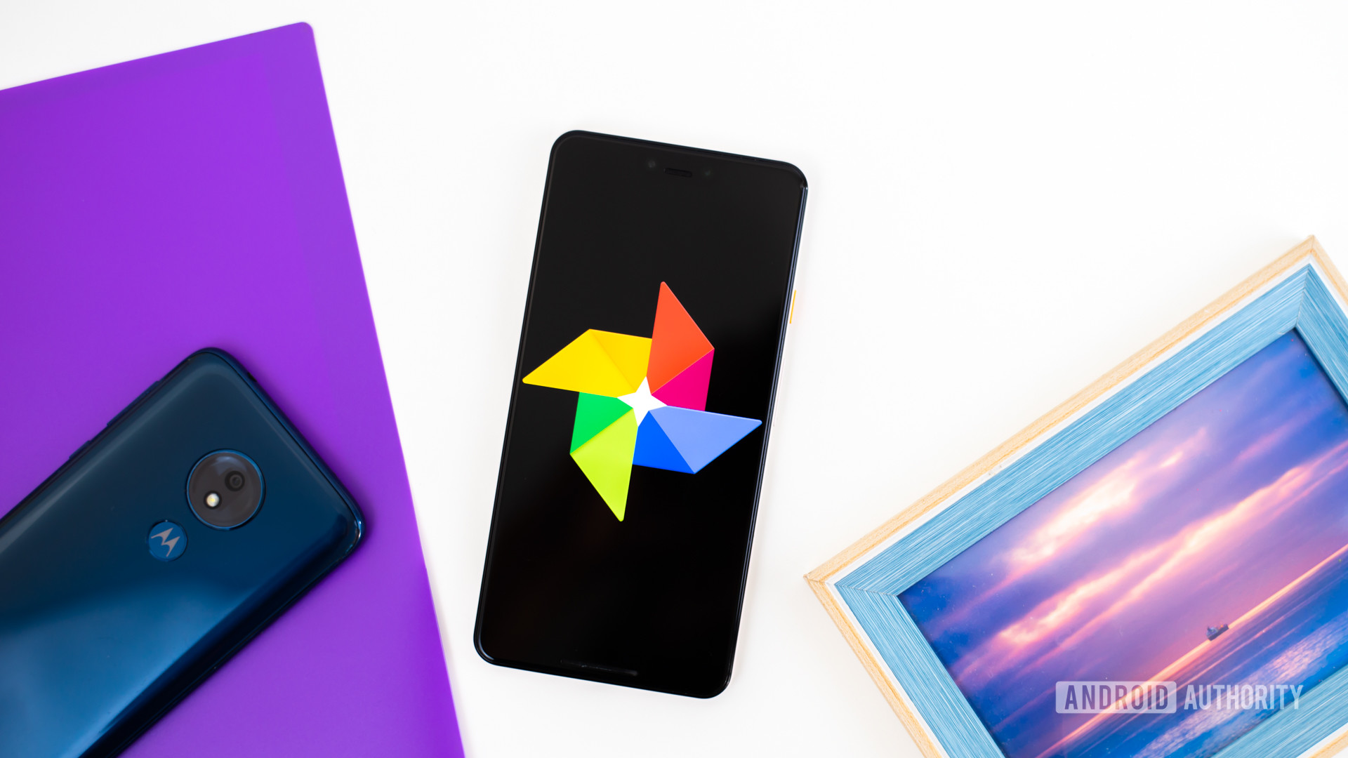 Google Photos logo on smartphone next to imaging accessories stock photo 1