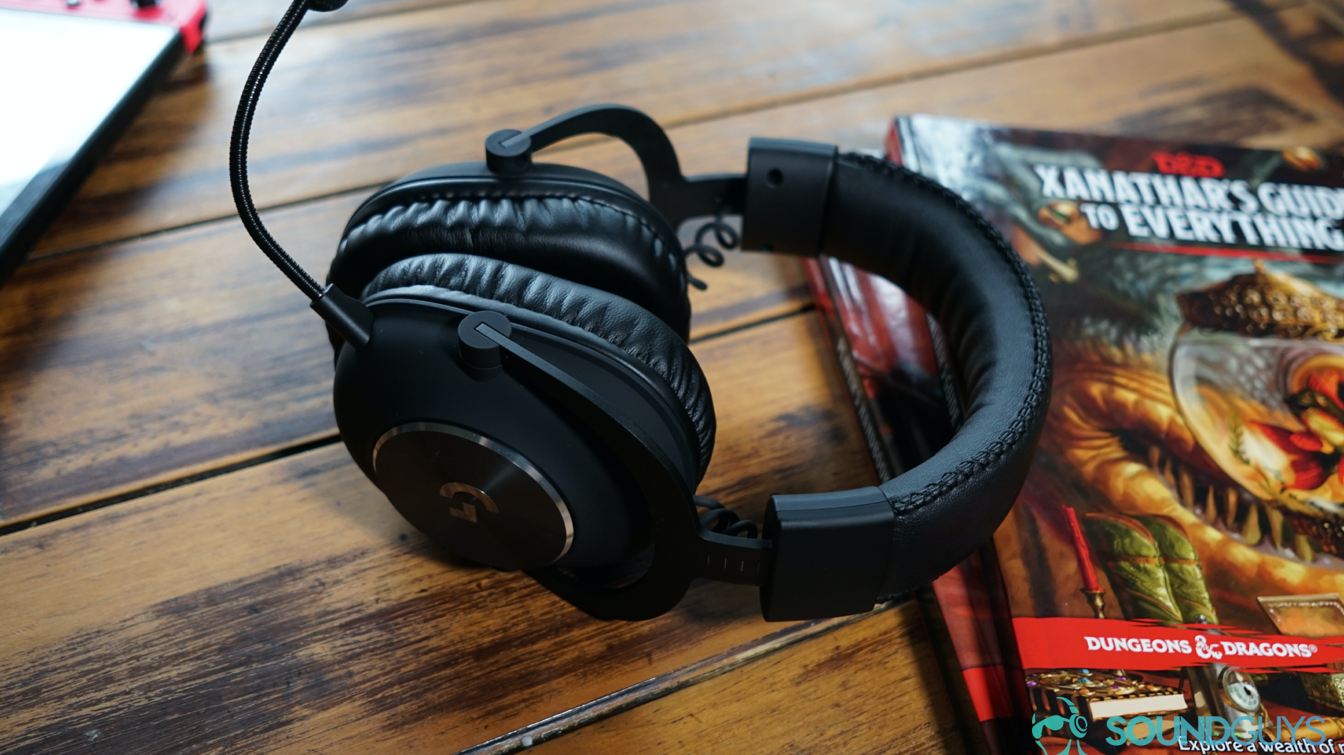 The Logitech G Pro X gaming headset leans on copies of Xanathar's Guide to Everything and the Dungeons and Dragons Players Handbook, with a Nintendo Switch in the background.