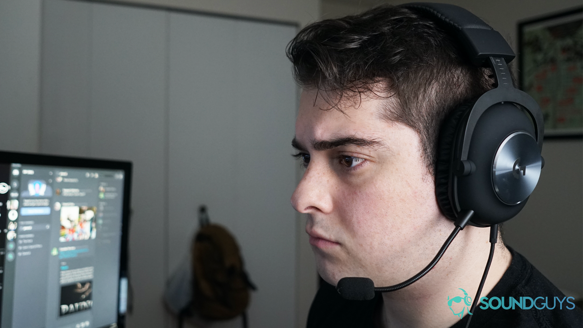 A man sits at a PC running Discord wearing The Logitech G Pro X gaming headset.