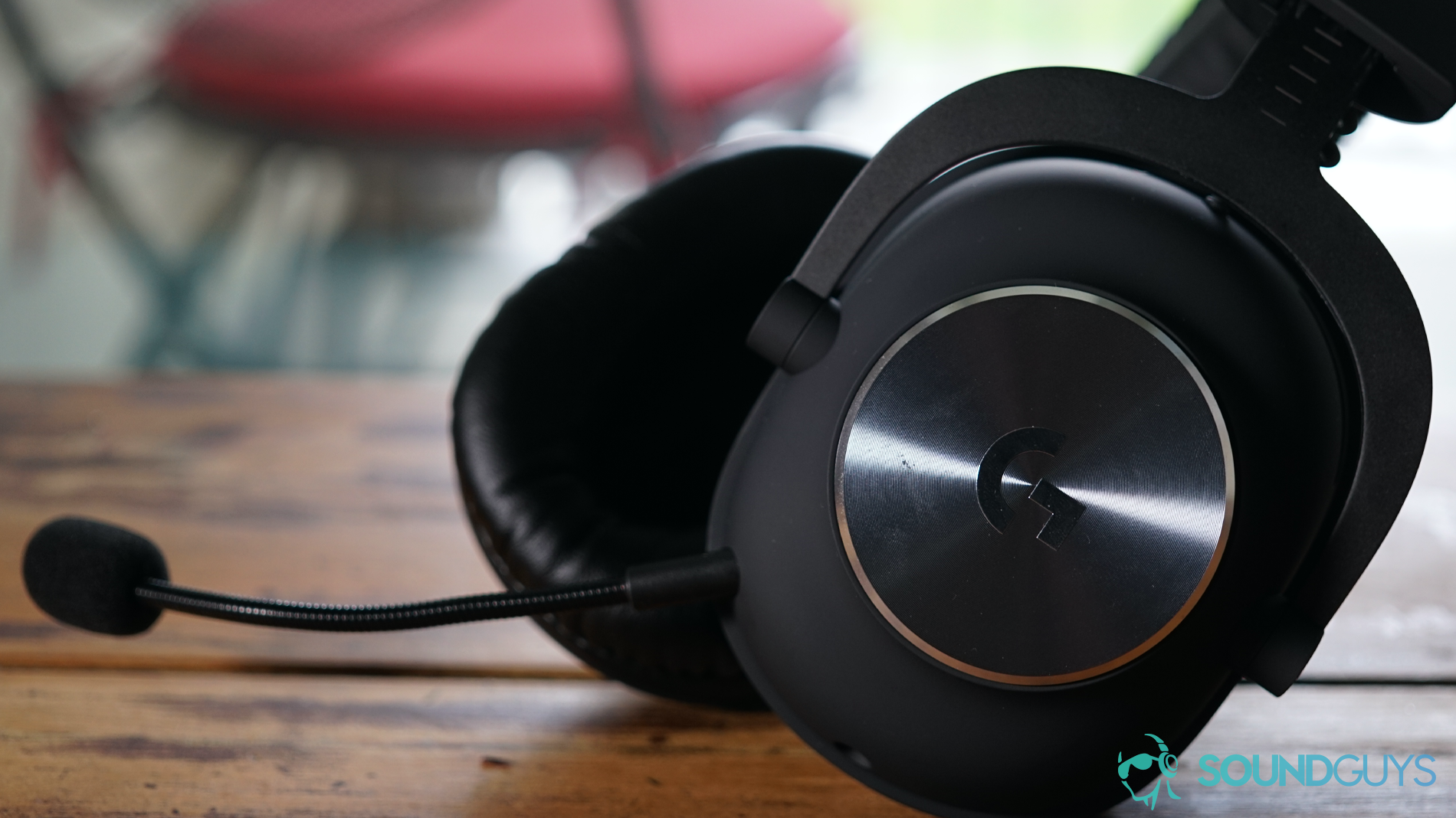 A picture of the Logitech G Pro X gaming headset in profile, sitting on a wooden surface.