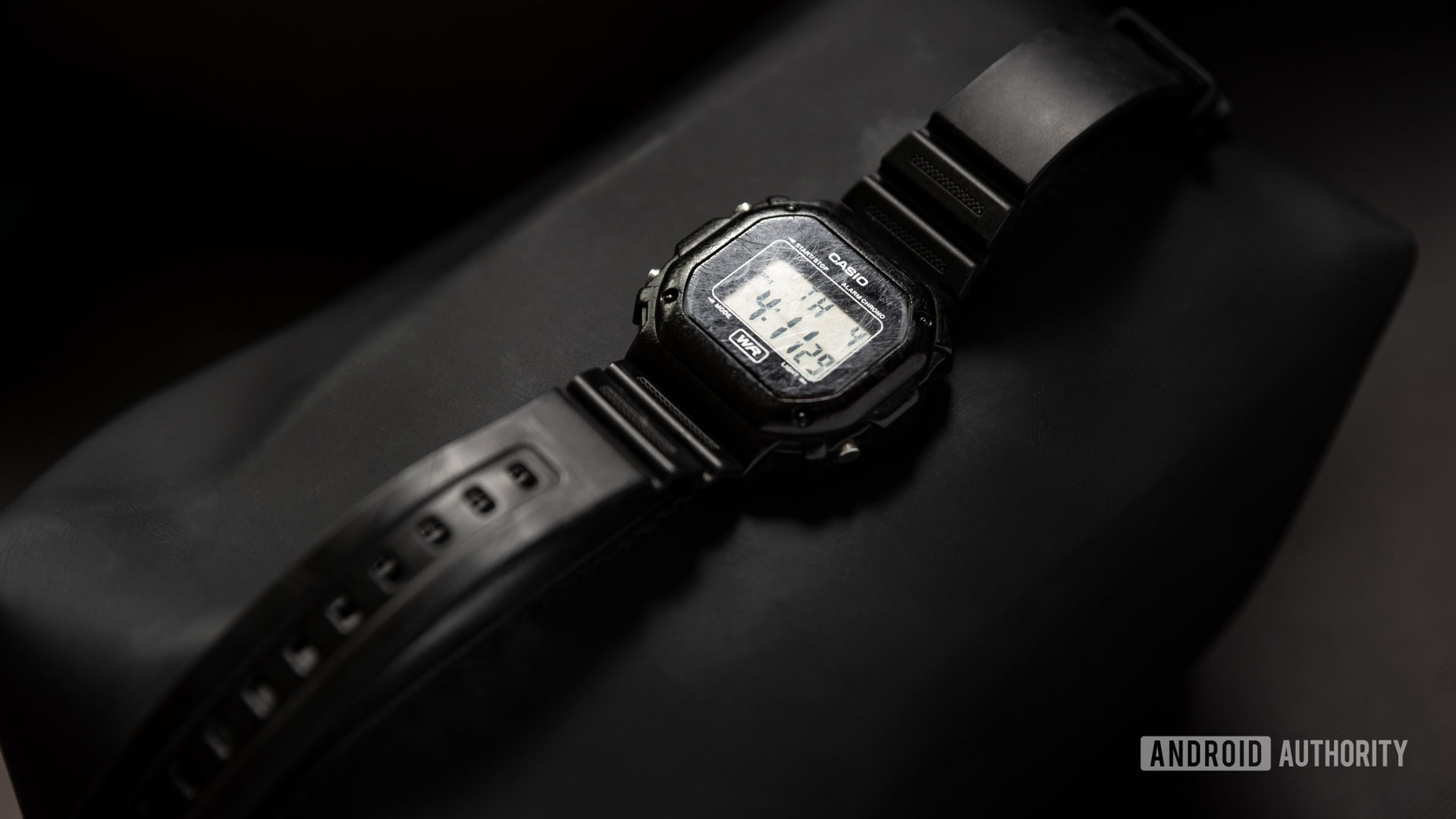 A picture of a black Casio F108WH Illuminator watch against a black surface.