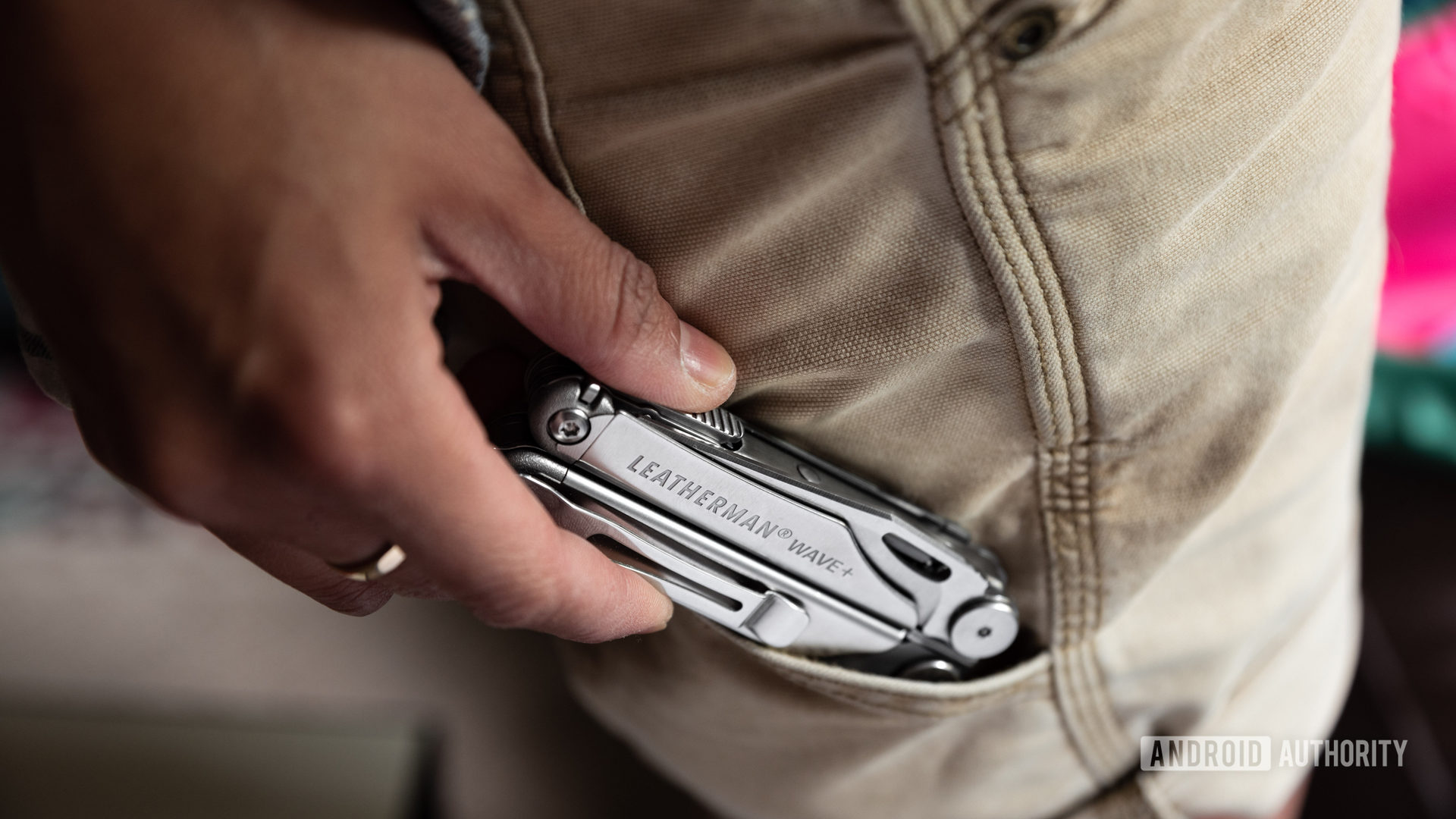 A picture of a Leatherman Wave Plus multitool being removed from a shorts pocket.
