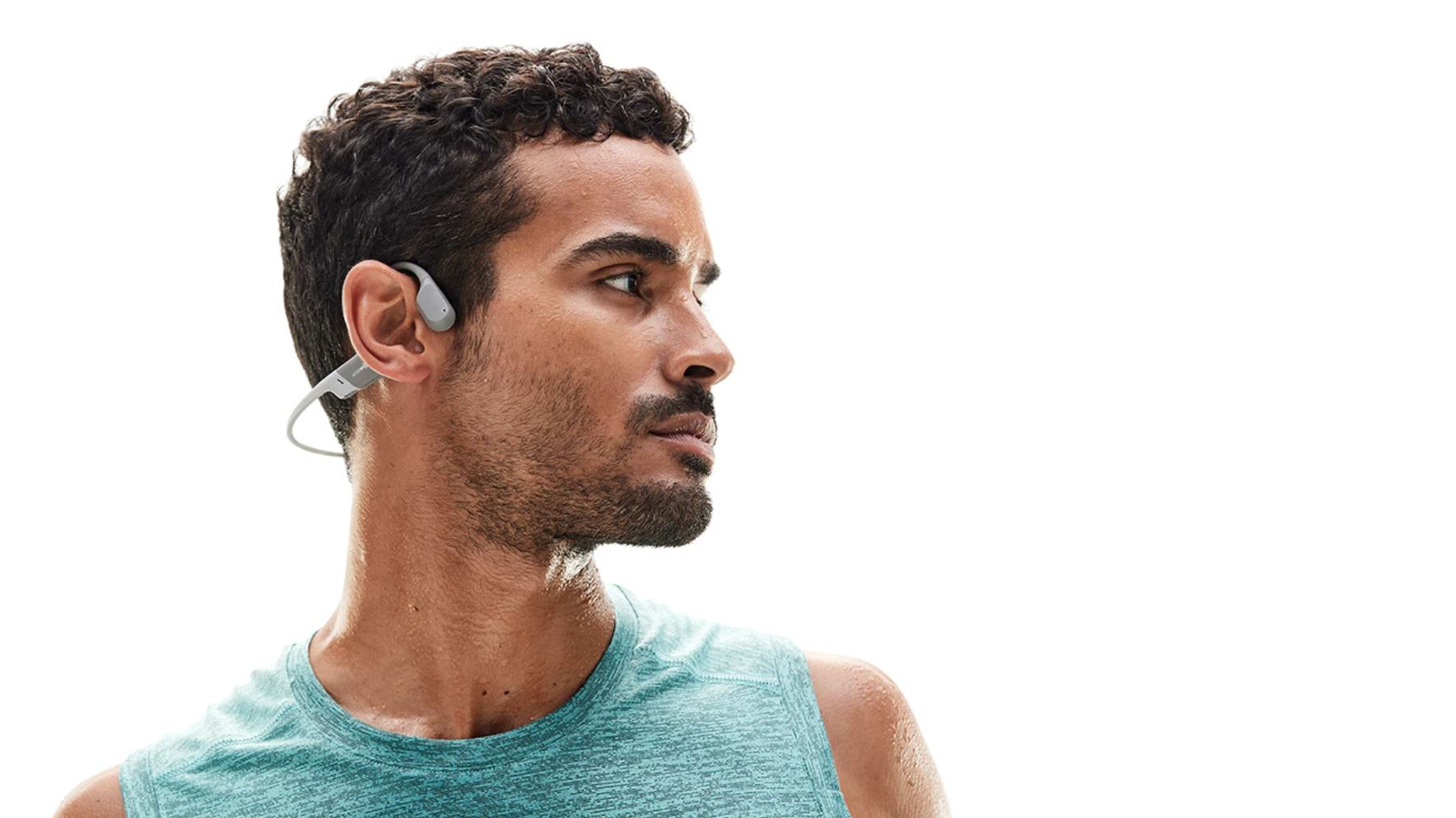 A picture of a man in profile wearing the AfterShokz Aeropex bone conduction headphones.
