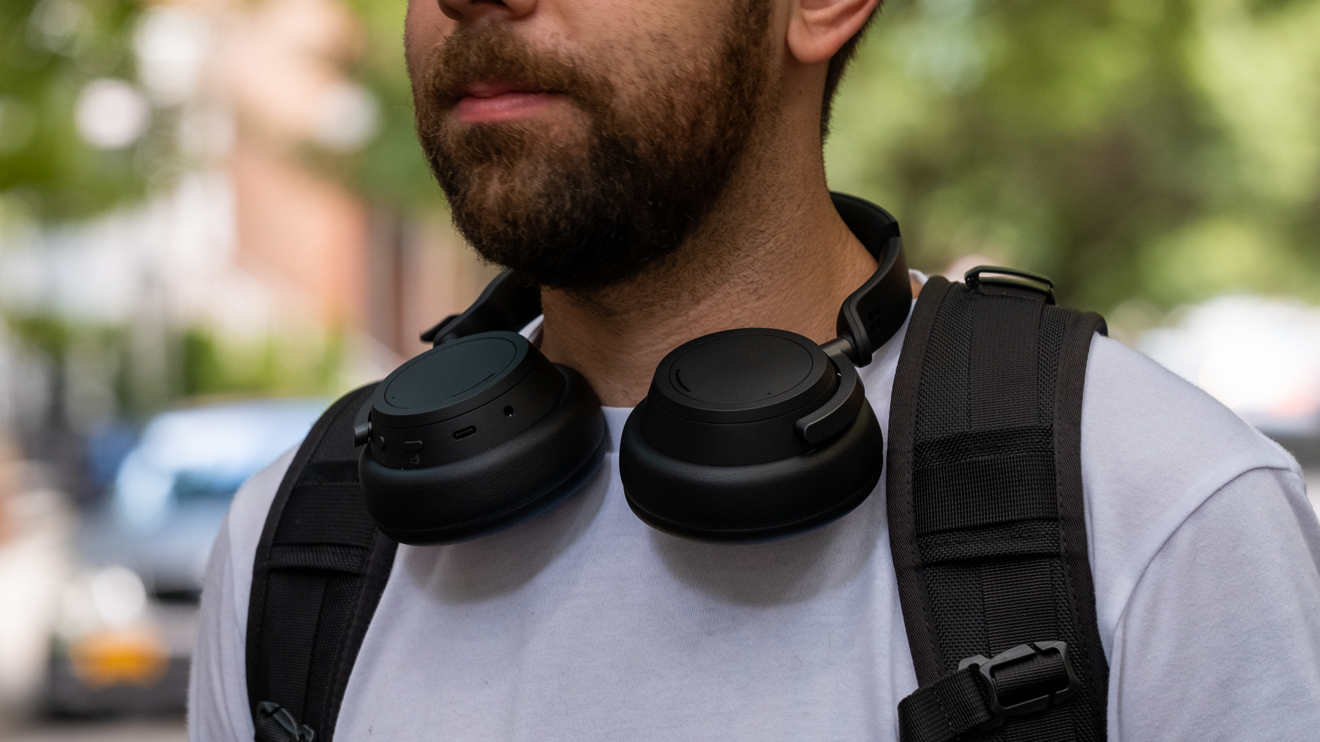 A man wearing the Surface Headphones 2 around his neck