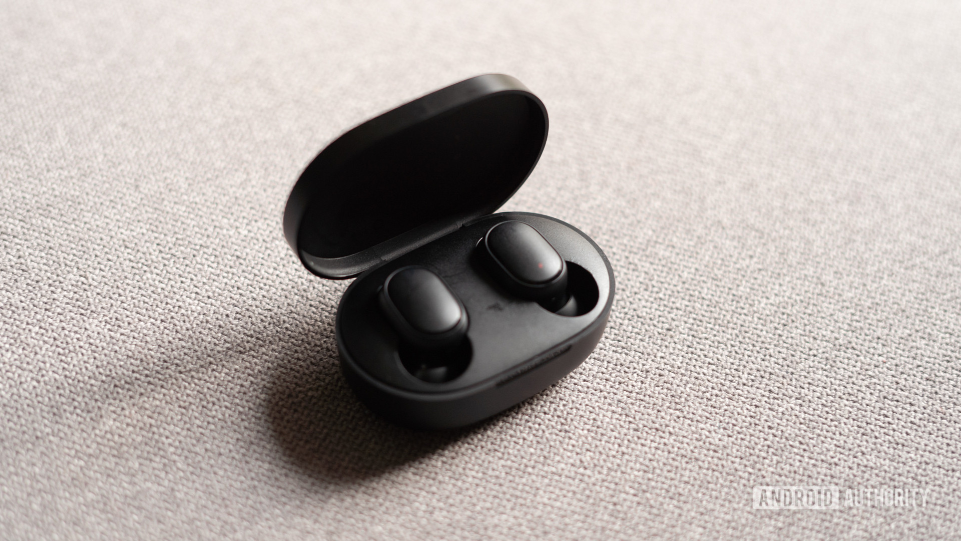 A picture of Redmi Earbuds S in charging case with lid open
