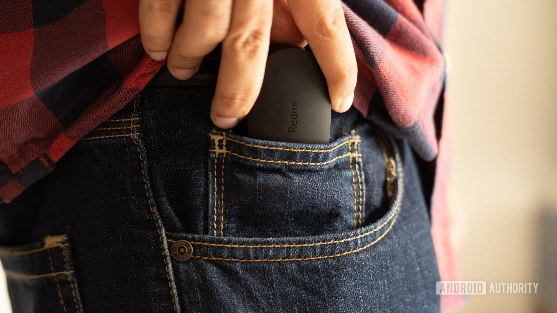 A picture of Redmi Earbuds S and case being slid into the pocket