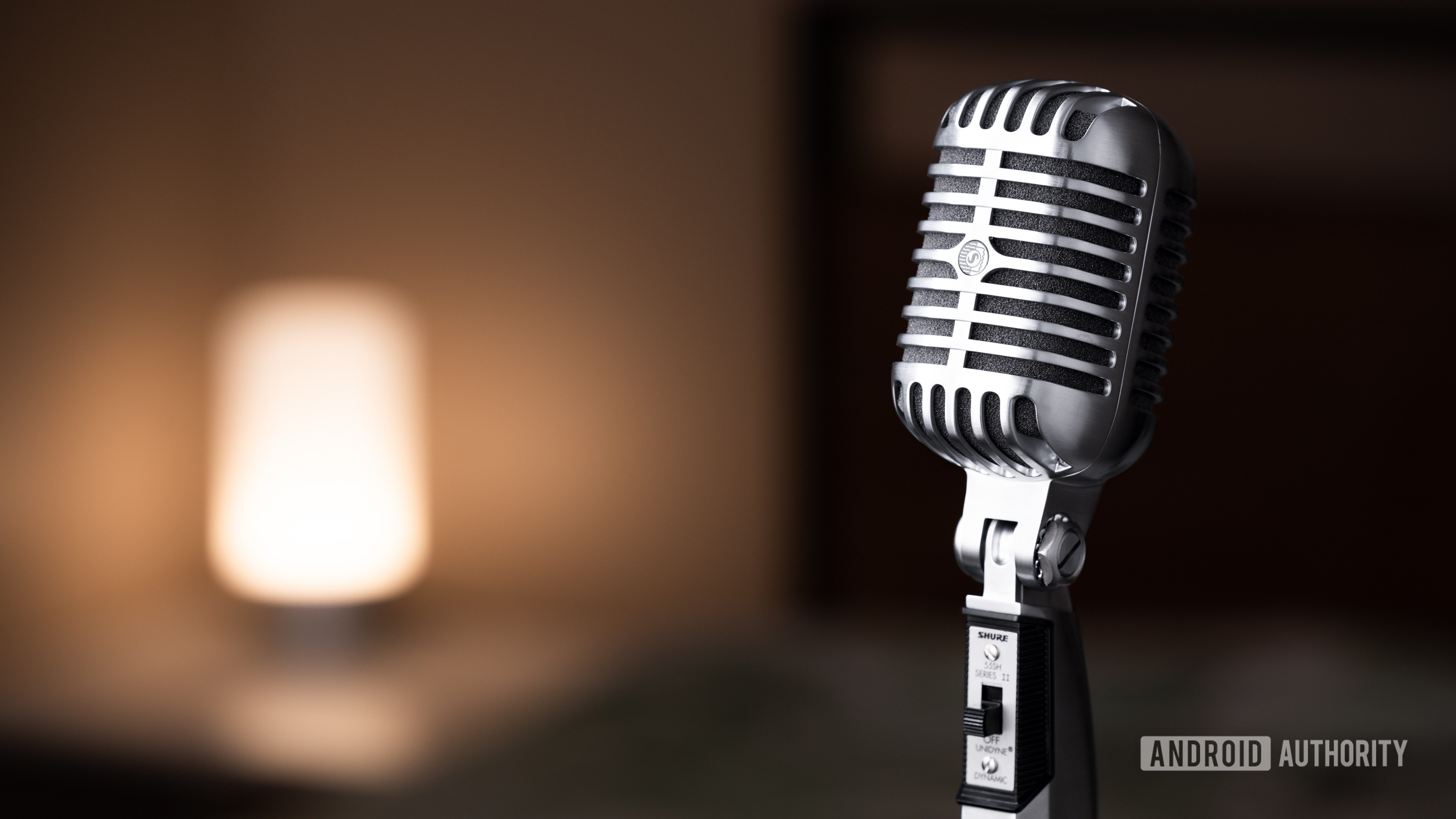 The Shure 55SH angled away from the camera with a warm light in the background.