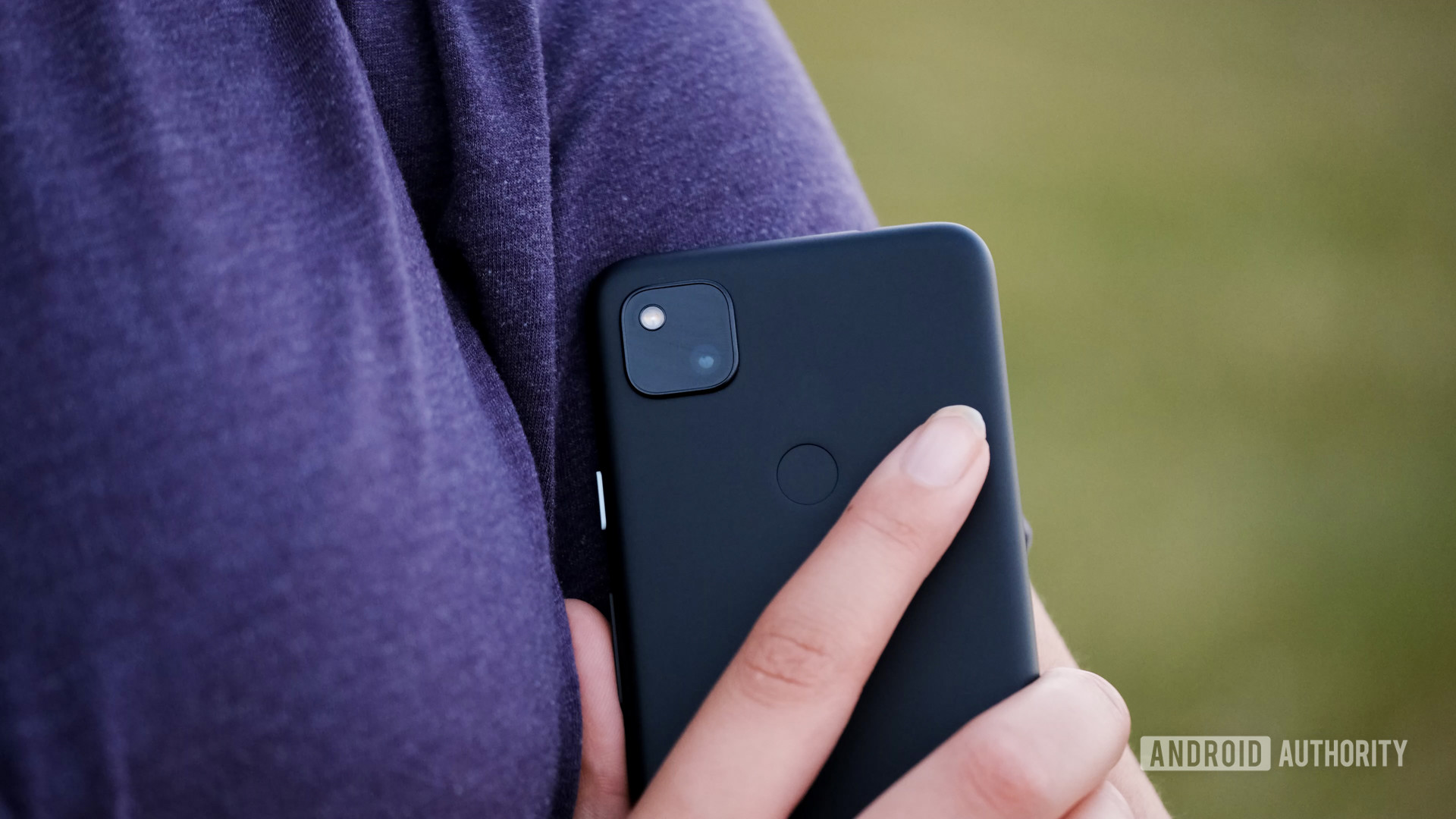 Google Pixel 4a in hand close to chest tight