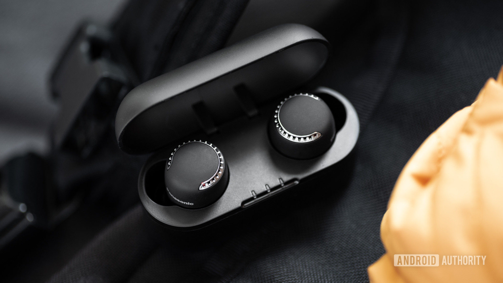 The Panasonic RZ-S500W noise cancelling earbuds both in the case, showing the LEDs on the buds.