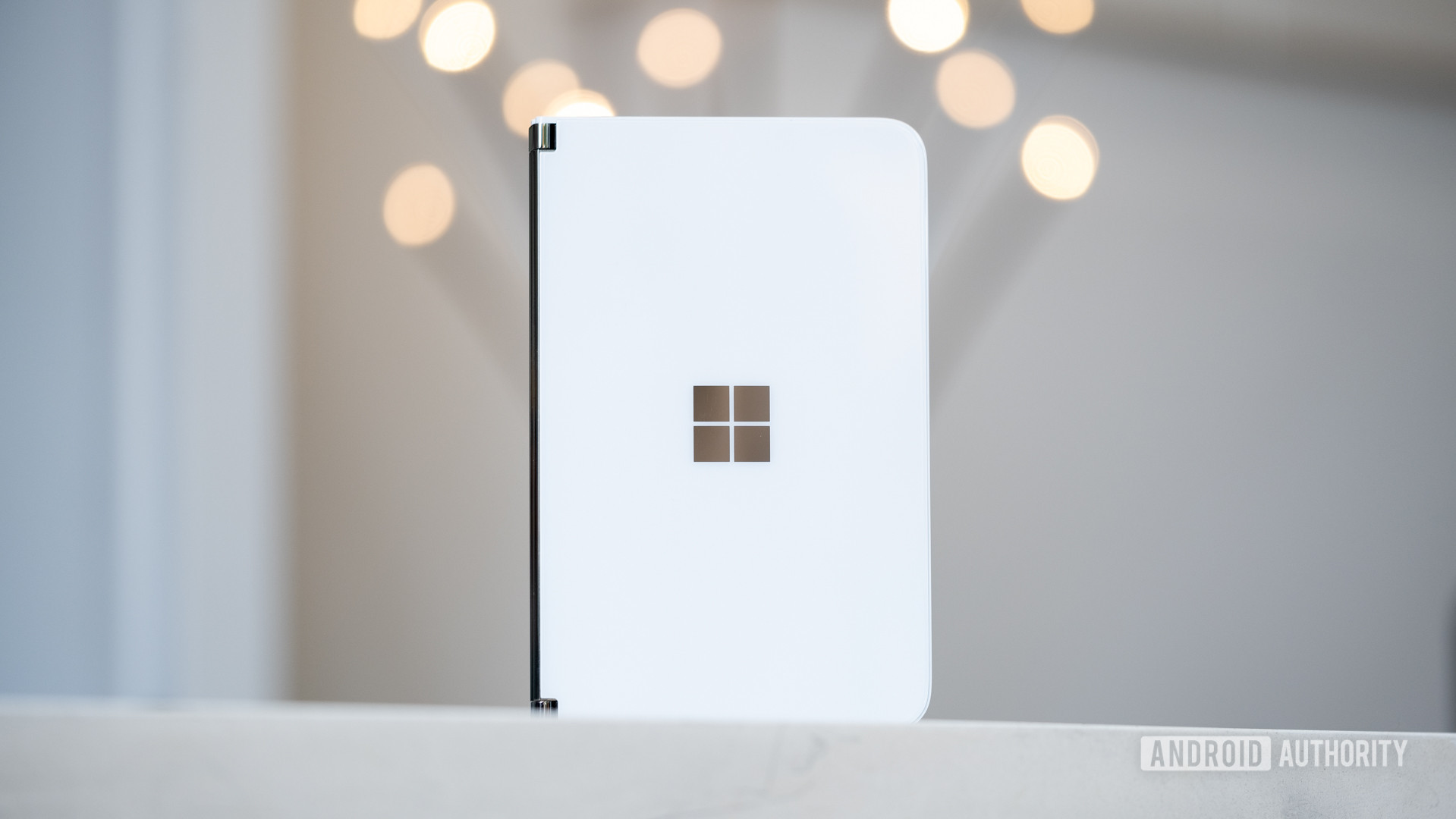 Microsoft Surface Duo standing upright on table closed