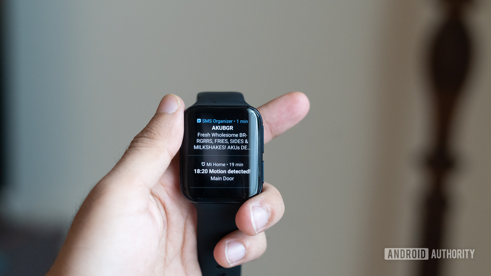 Oppo Watch in hand showing notifications