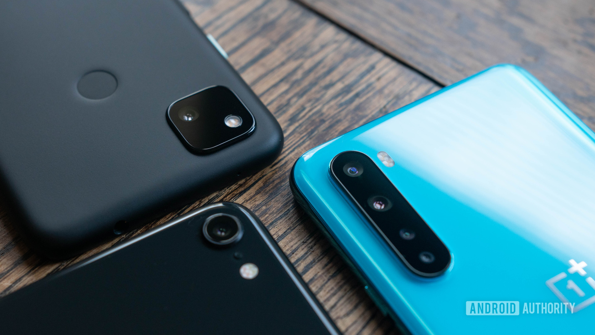 Pixel 4a vs iPhone SE vs OnePlus Nord cameras together angled