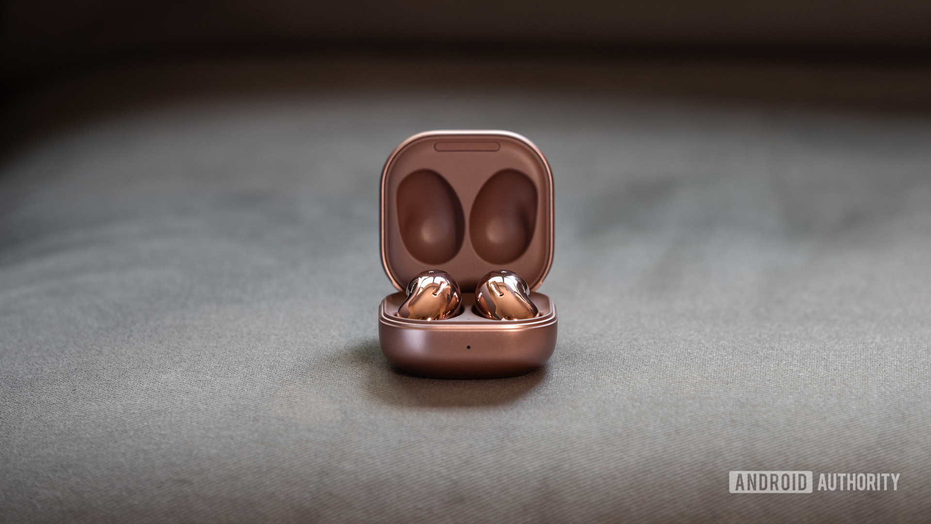 A picture of the Samsung Galaxy Buds Live noise cancelling true wireless earbuds in the case against a gray background.