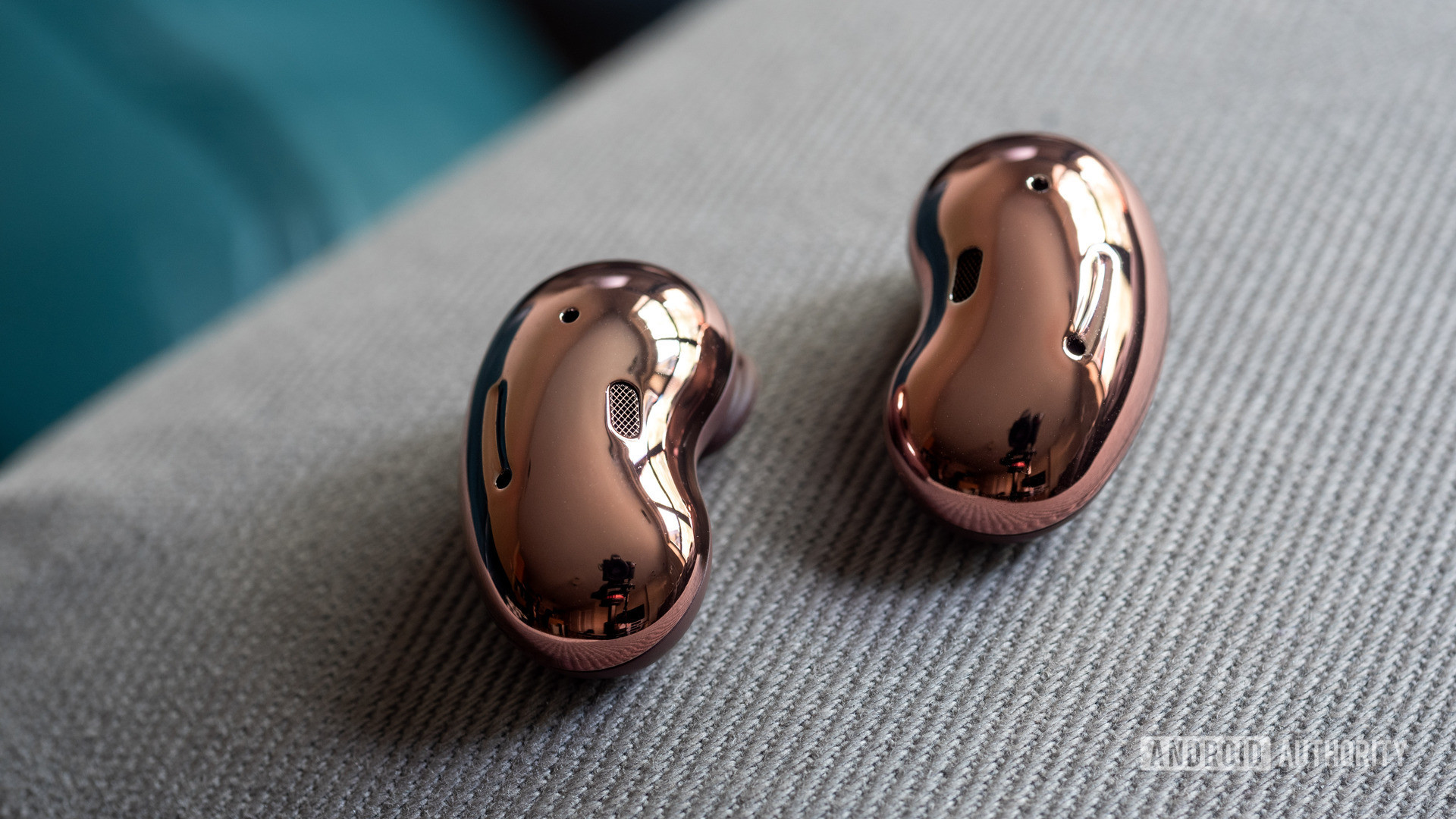 A picture of the Samsung Galaxy Buds Live noise cancelling true wireless earbuds bean shaped, reflective exteriors.