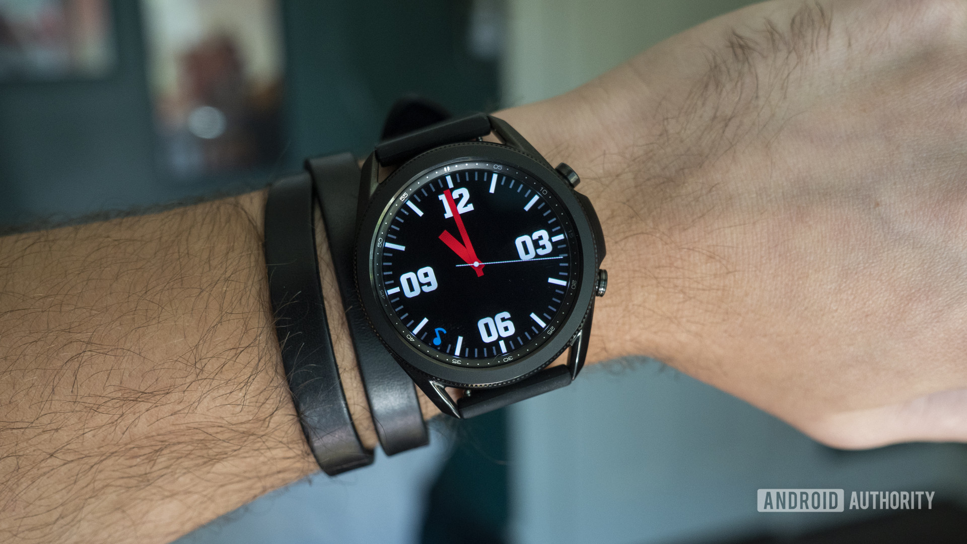 A Samsung Galaxy Watch 3 on a user's wrist displays the the time.