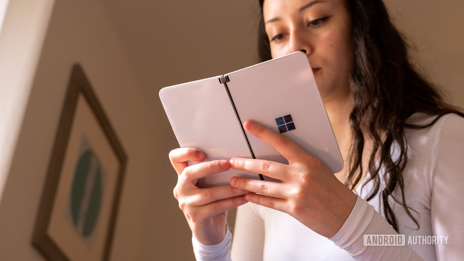 Microsoft Surface Duo in hand book mode from under