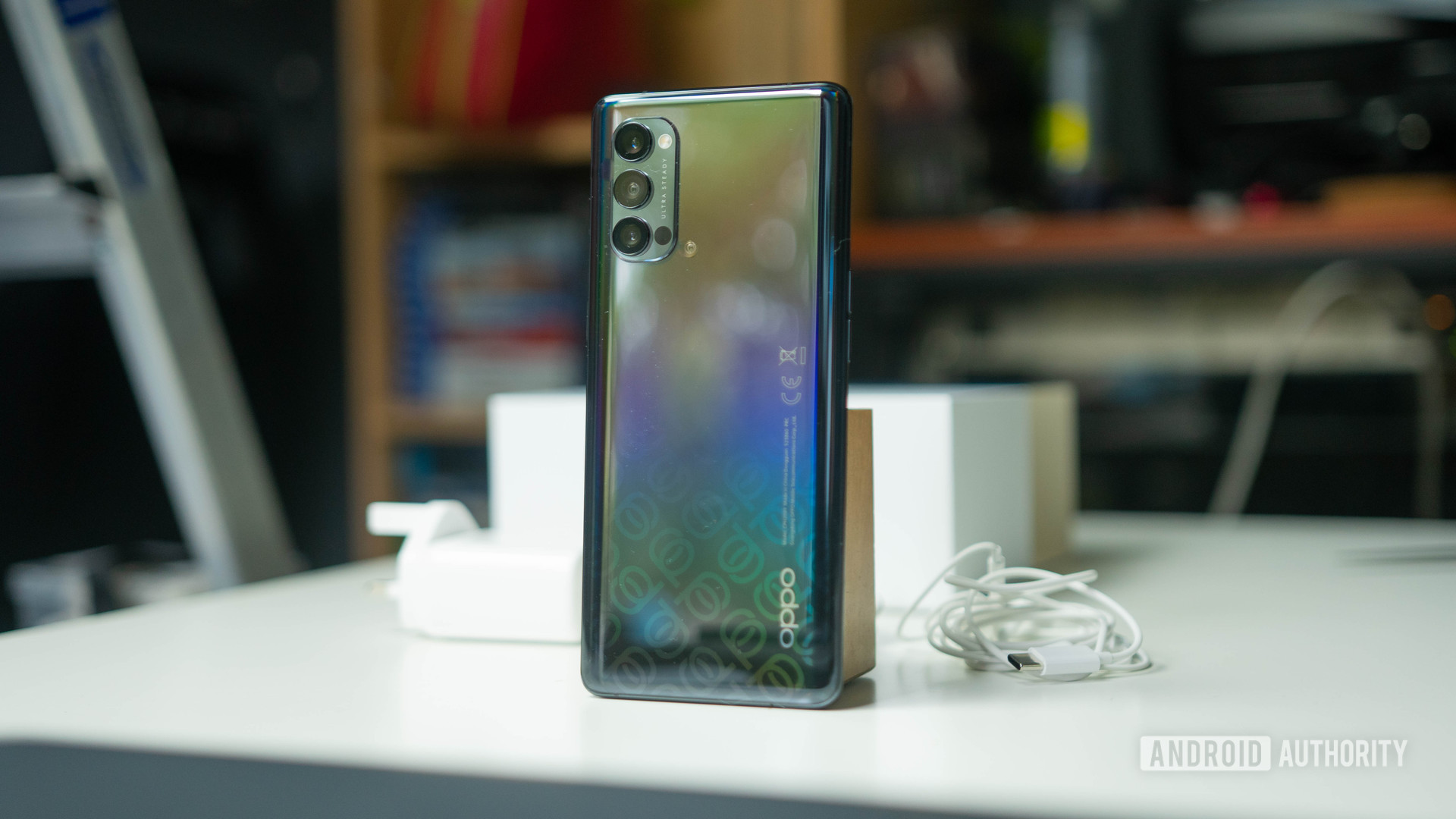 OPPO Reno 4 Pro 5G rear shot on a desk next to the charger and box