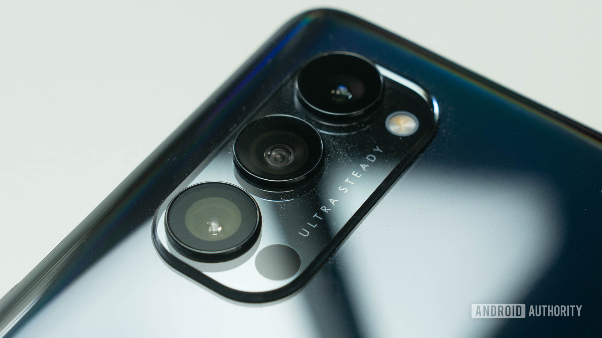 OPPO Reno 4 Pro 5G rear triple camera bump at an angle and on a white table