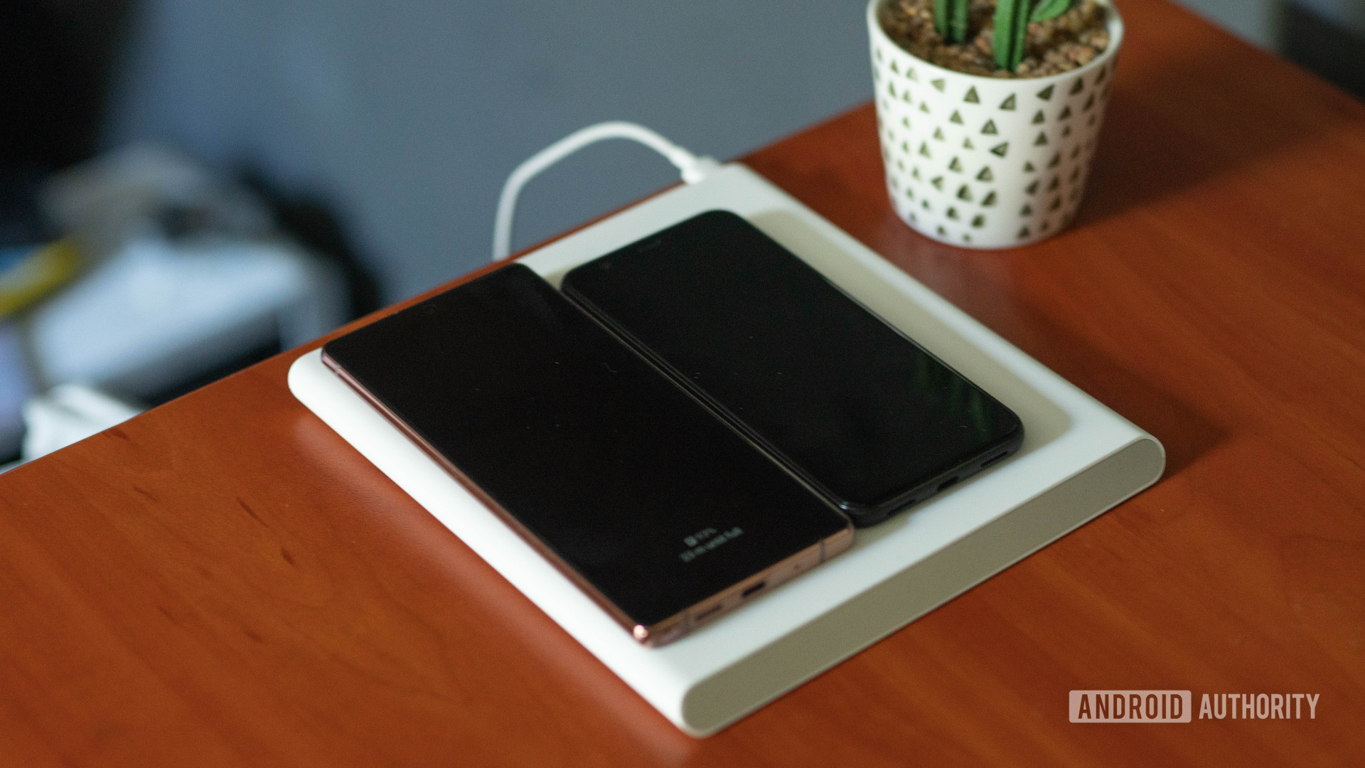 Xiaomi Mi 20W Smart Tracking Wireless Charging Pad with two phones charging