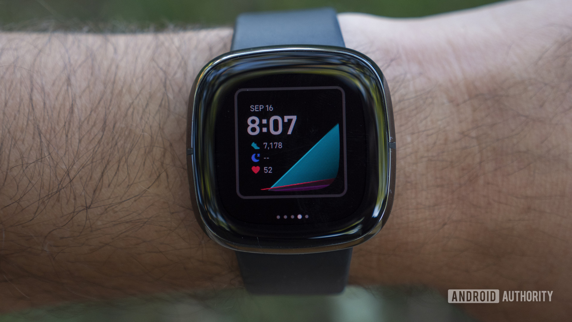A man wearing a Fitbit Sense navigates his watch face selections