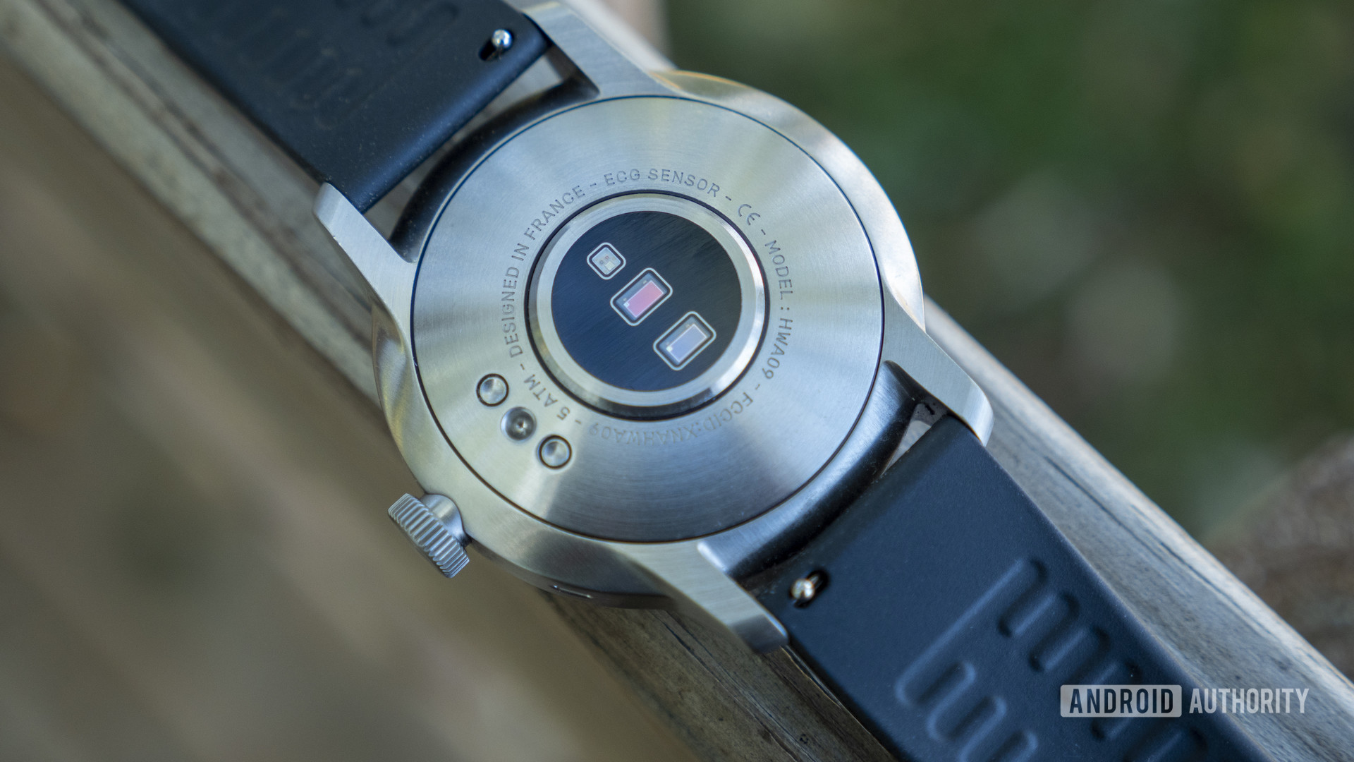 A Withings ScanWatch rests face down, displaying the sensors the watch uses to sleep track.