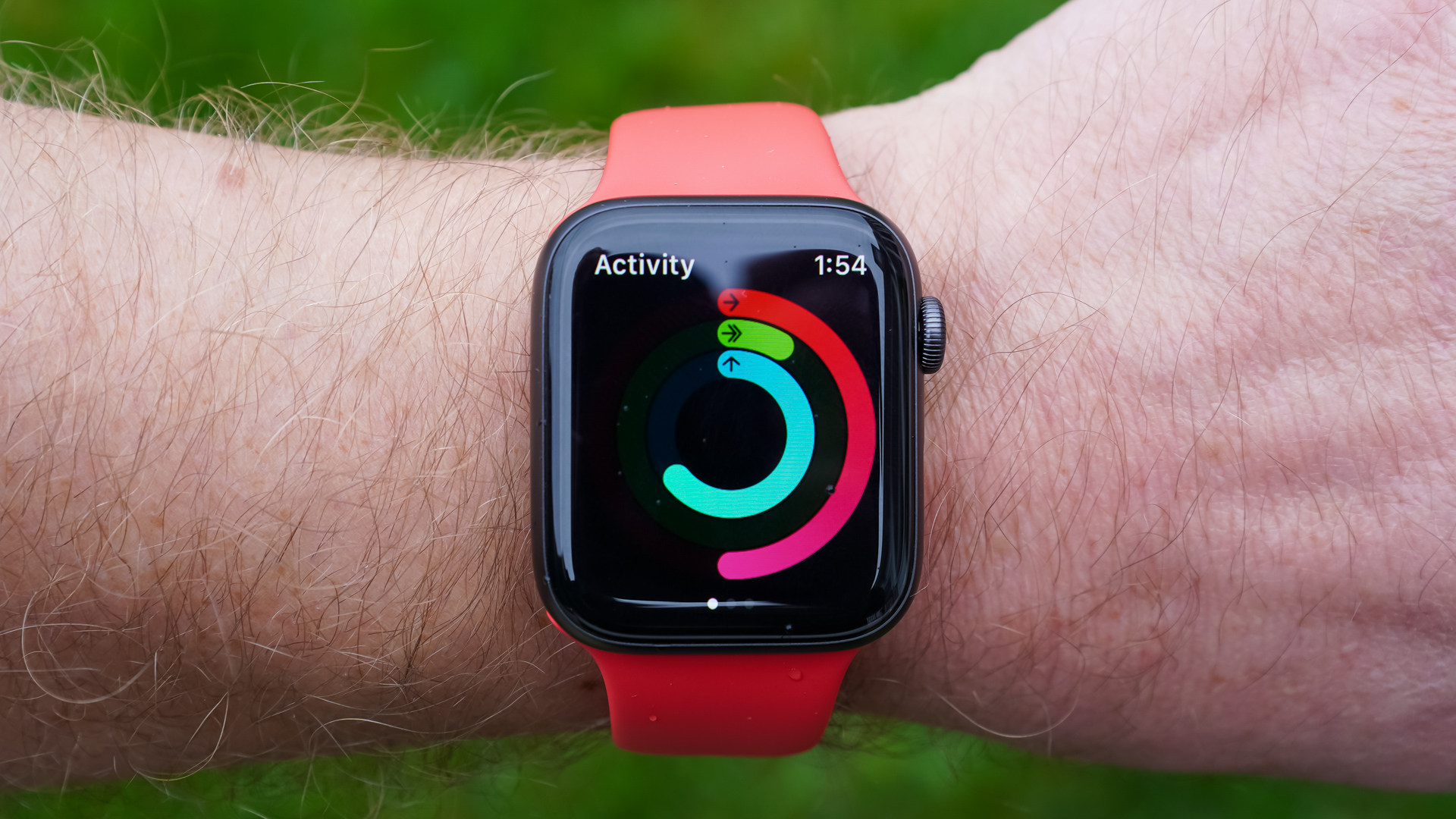 An Apple Watch SE on a user's wrist displays their activity rings.