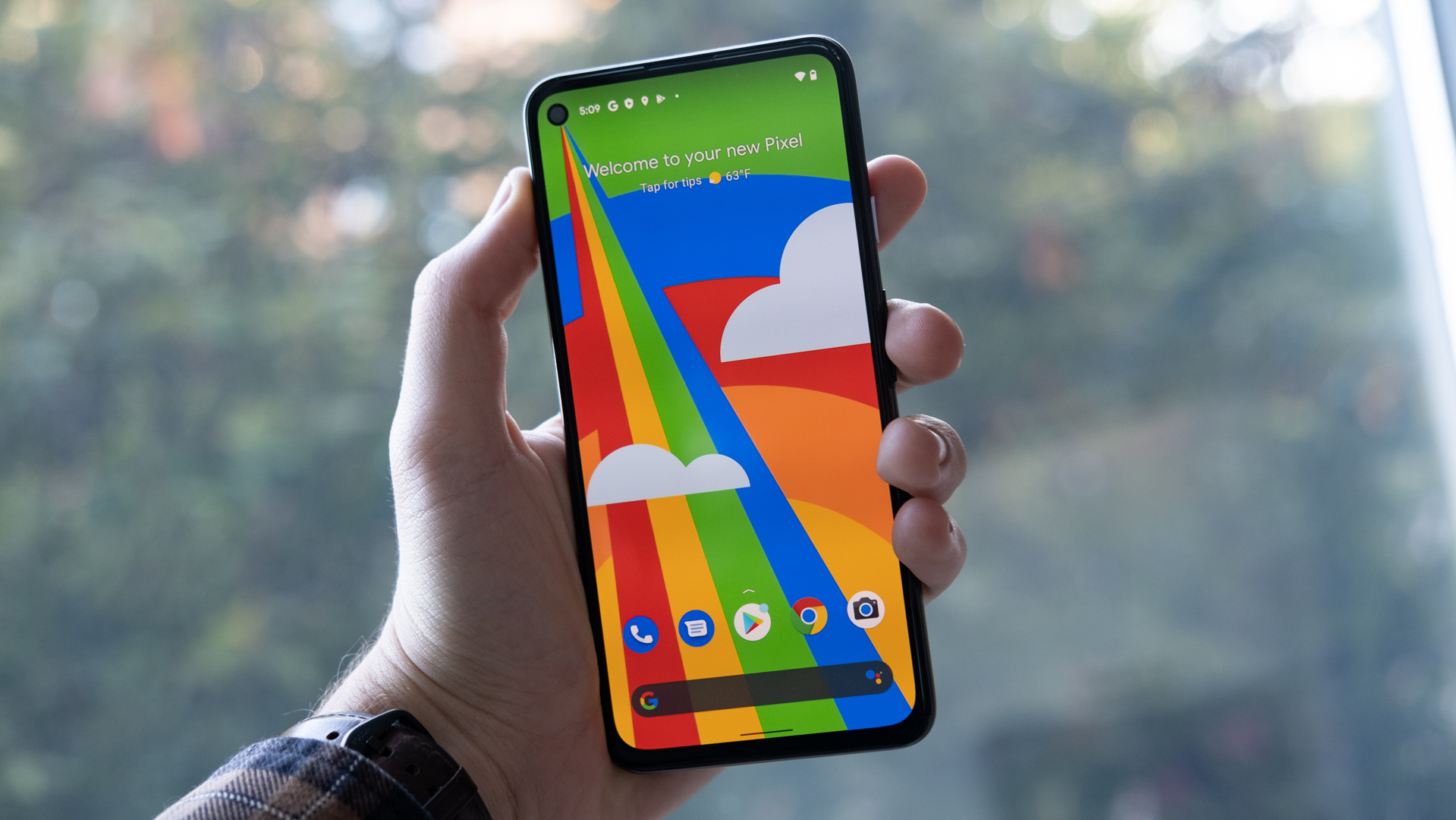 Google Pixel 4a 5G in hand front of phone 1