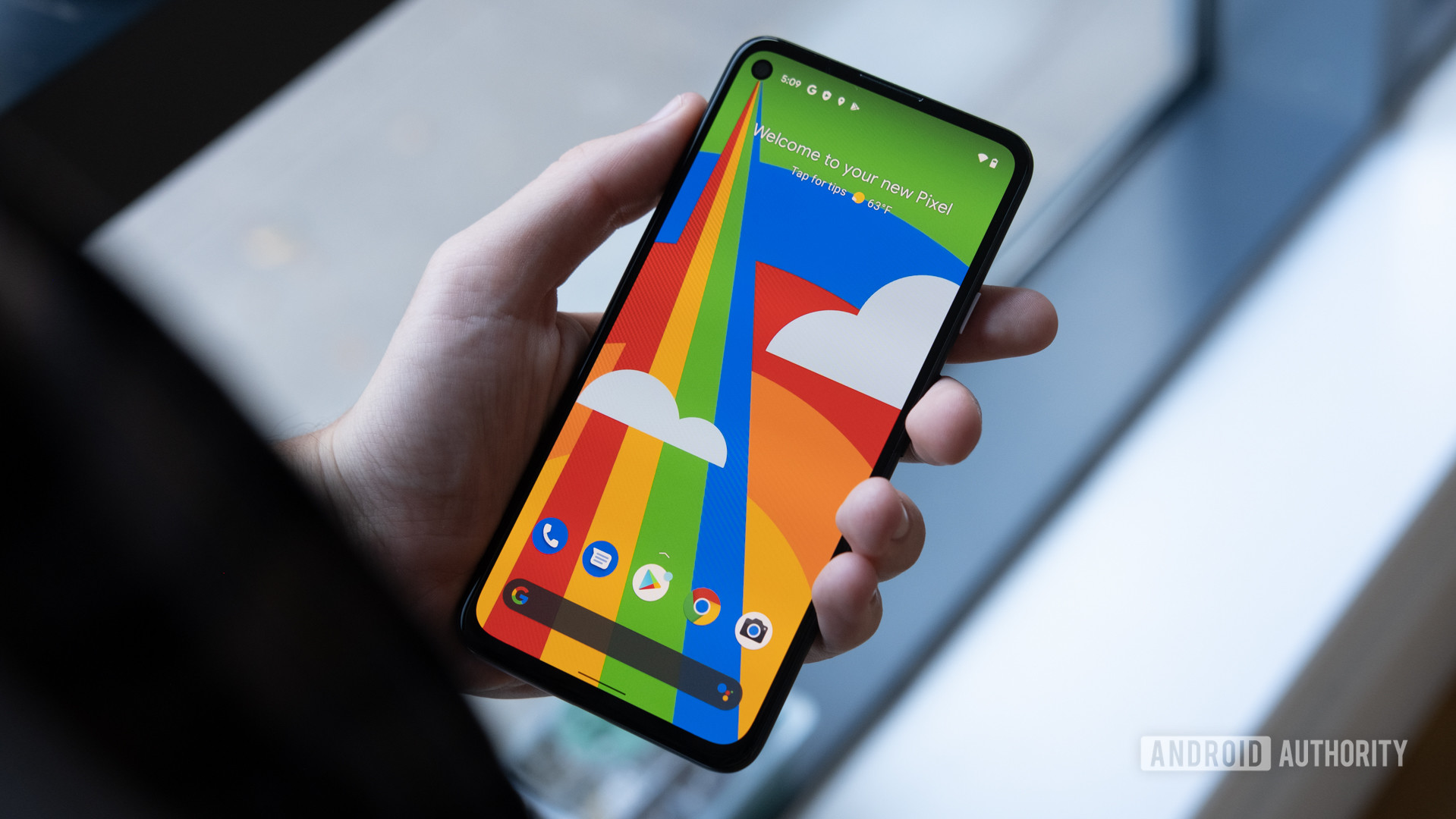 Google Pixel 4a 5G in hand showing screen.