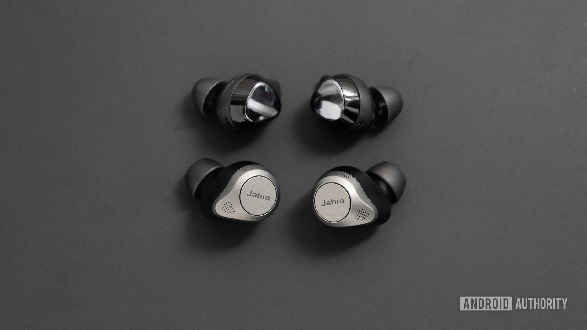 The Jabra Elite 85t noise cancelling true wireless earbuds compared to the Samsung Galaxy Buds Plus, which are smaller than Jabra's buds.