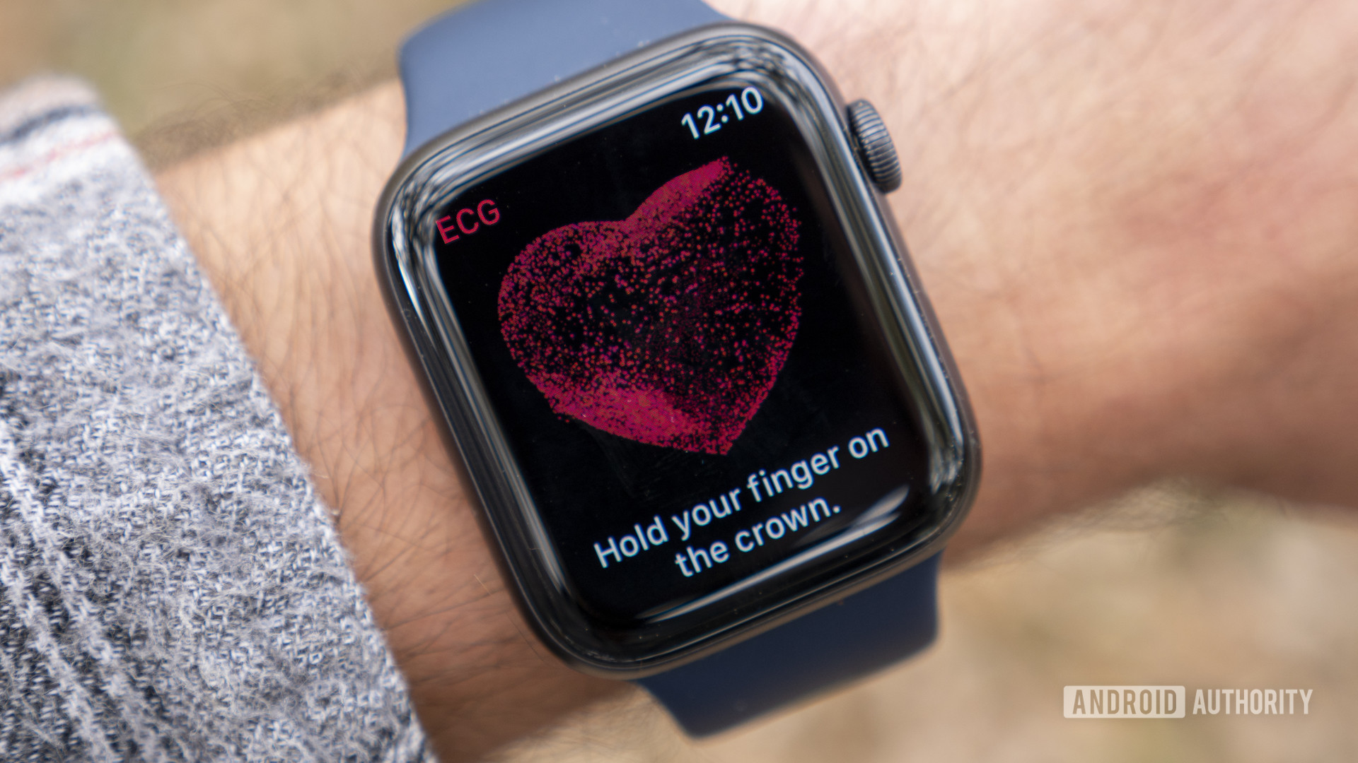 An Apple Watch Series 6 on a user's wrist displays the ECG prompt screen. 