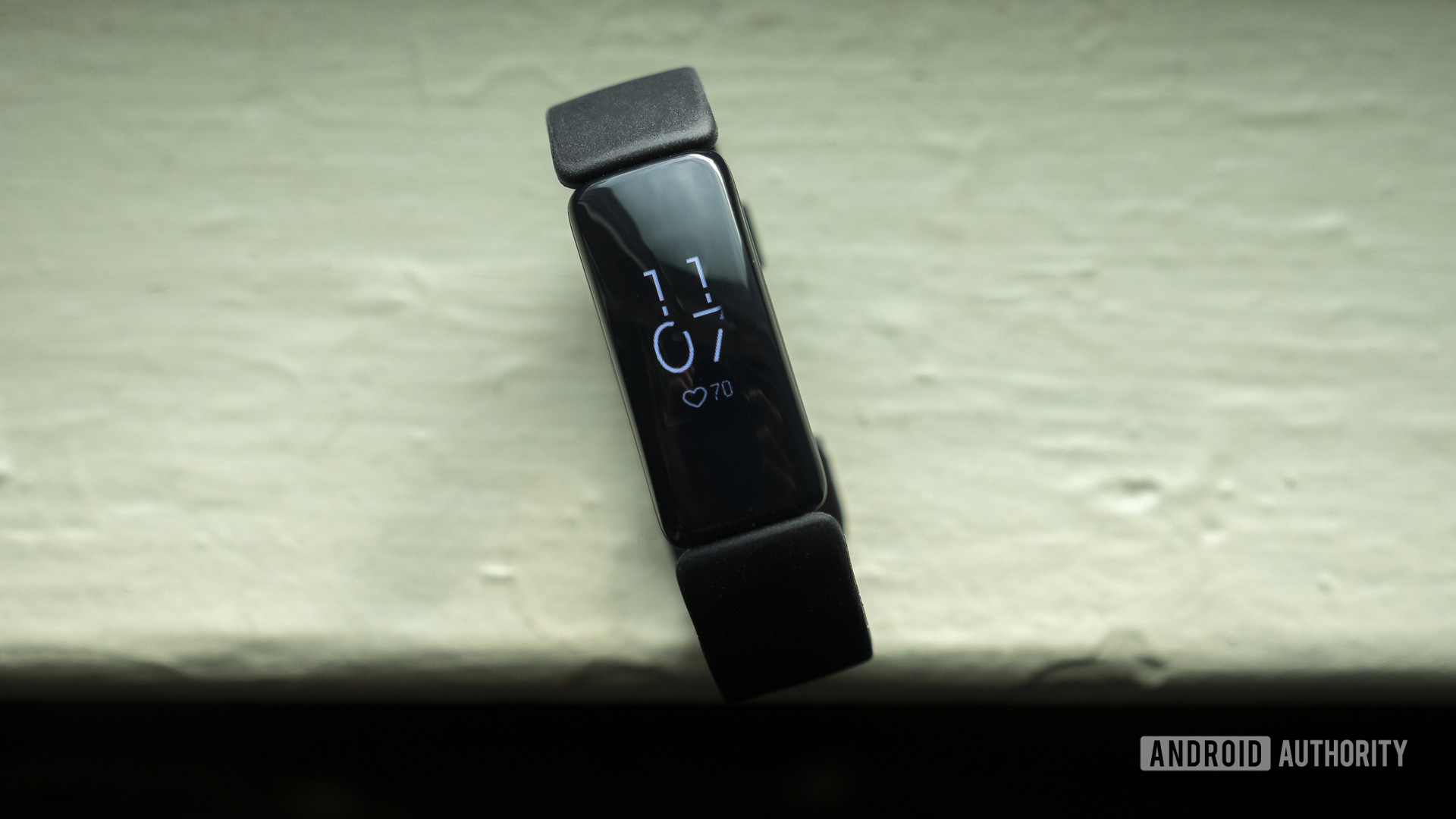 fitbit inspire 2 review fitness tracker display on table 2